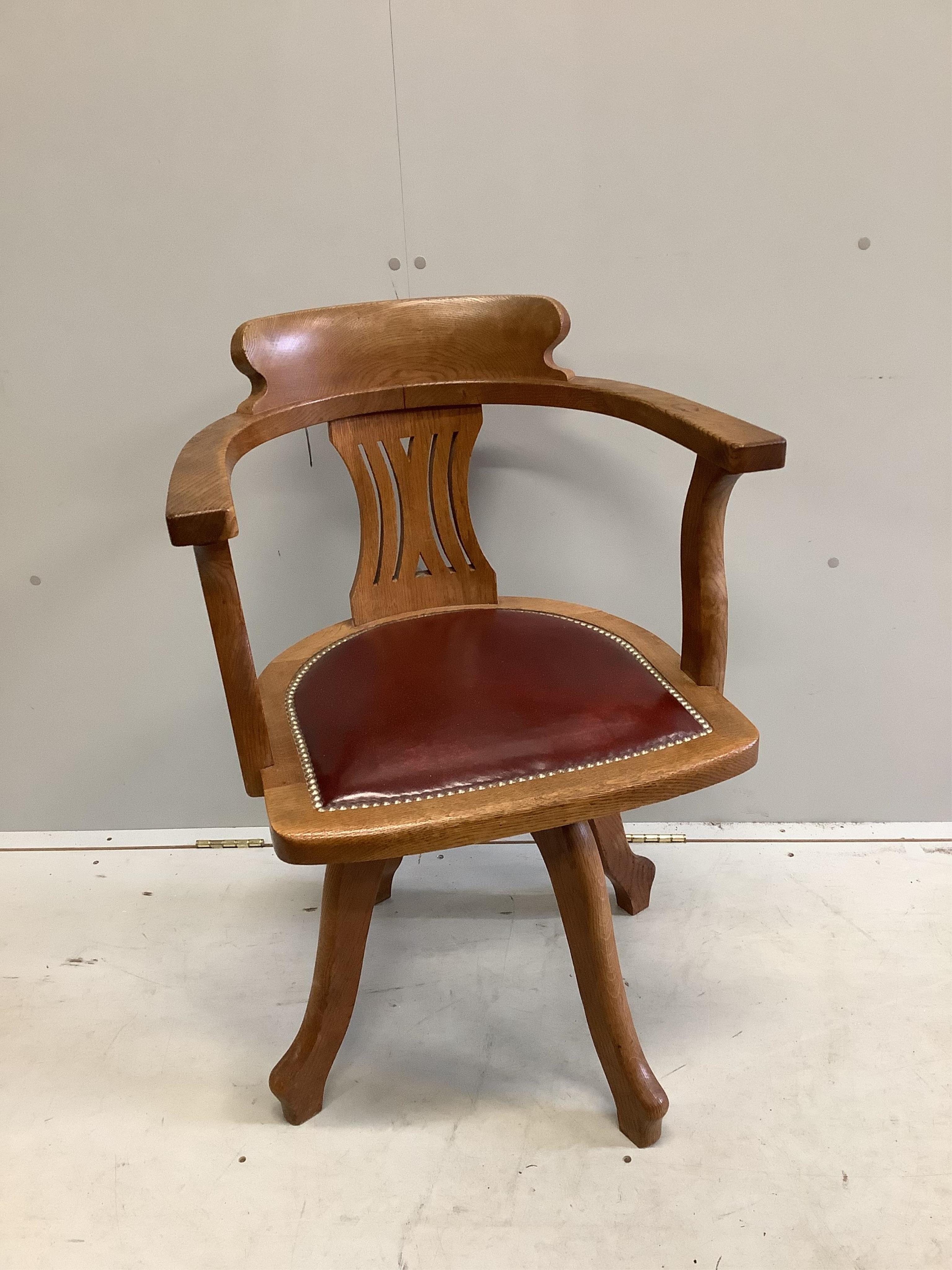 An early 20th century oak swivel desk chair with leather seat, width 61cm, depth 52cm, height 87cm. Condition - fair to good                                                                                                