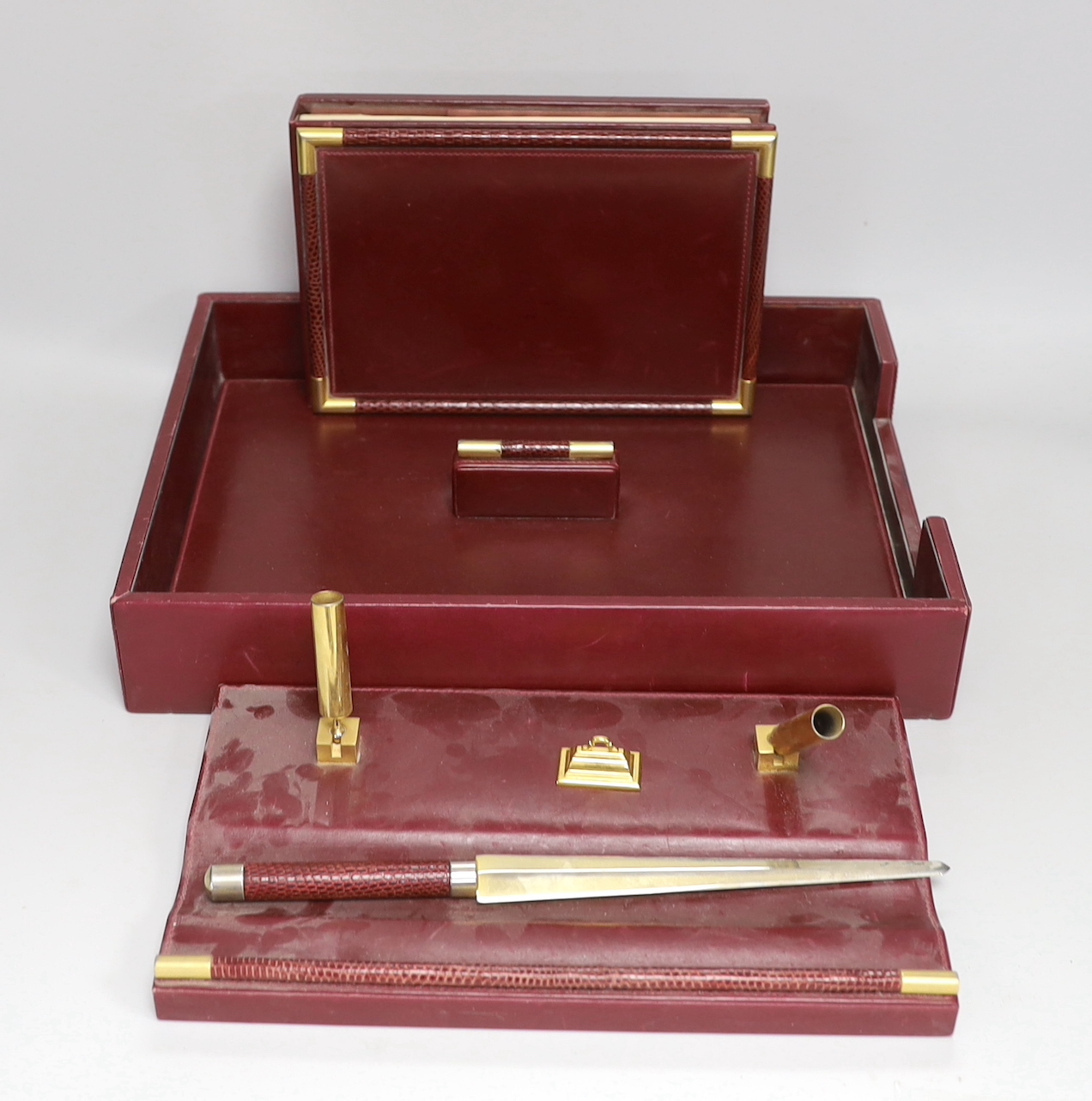 An Asprey red leather three piece desk set, tray 34.5cm long x 26cm wide, faux crocodile edges                                                                                                                              