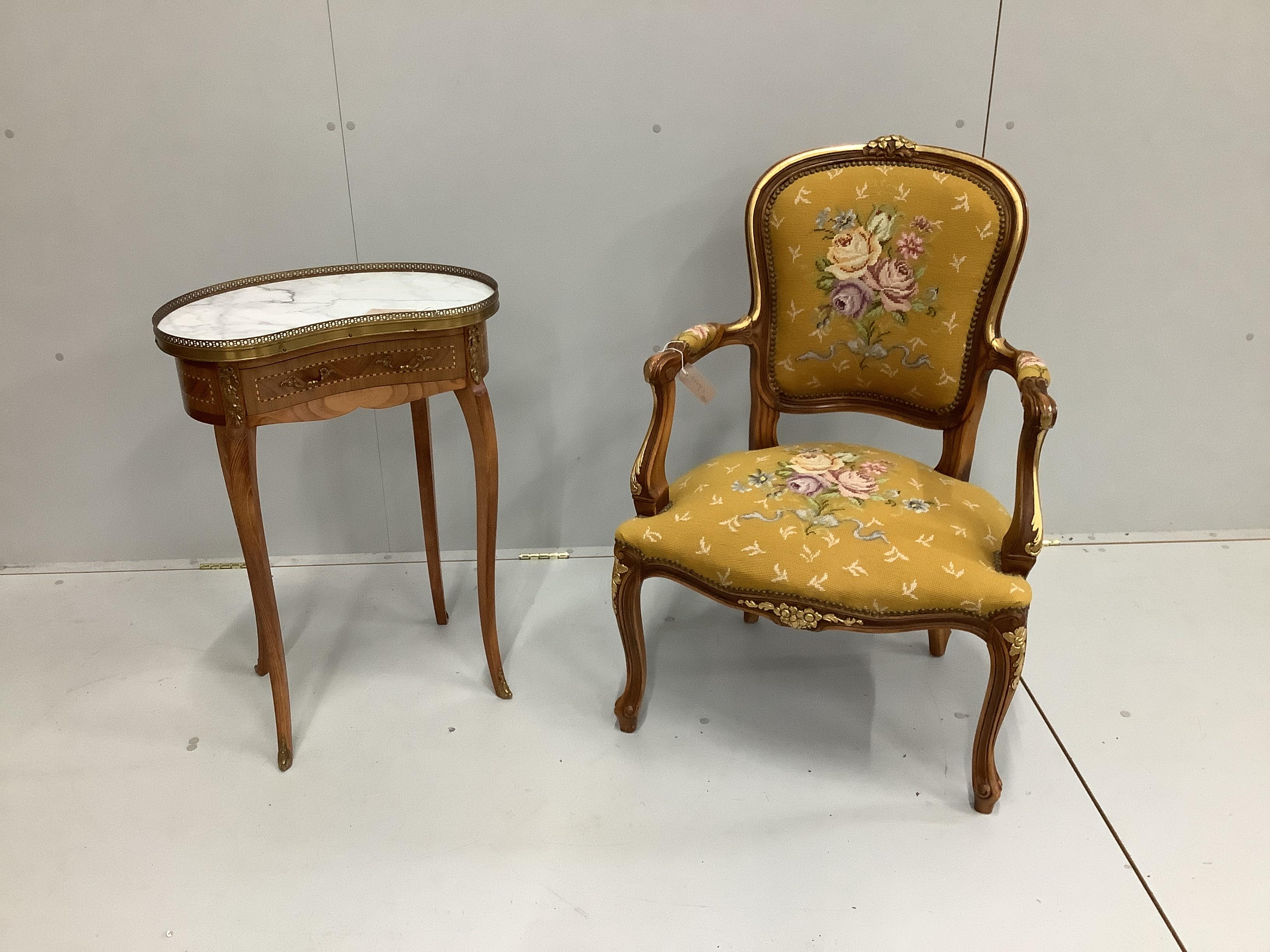 A reproduction Louis XV style gueridon, with inlaid decoration, marble top and gilt metal mounts, width 51cm, depth 32cm, height 74cm together with a Louis XV style fauteuil with floral needlework seat and back          