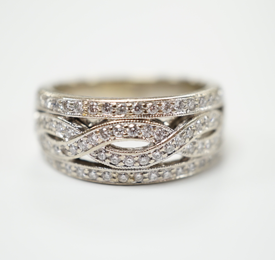 A modern 14ct gold and diamond chip set spiral band cluster half hoop ring, size L, gross weight 7.3 grams.                                                                                                                 