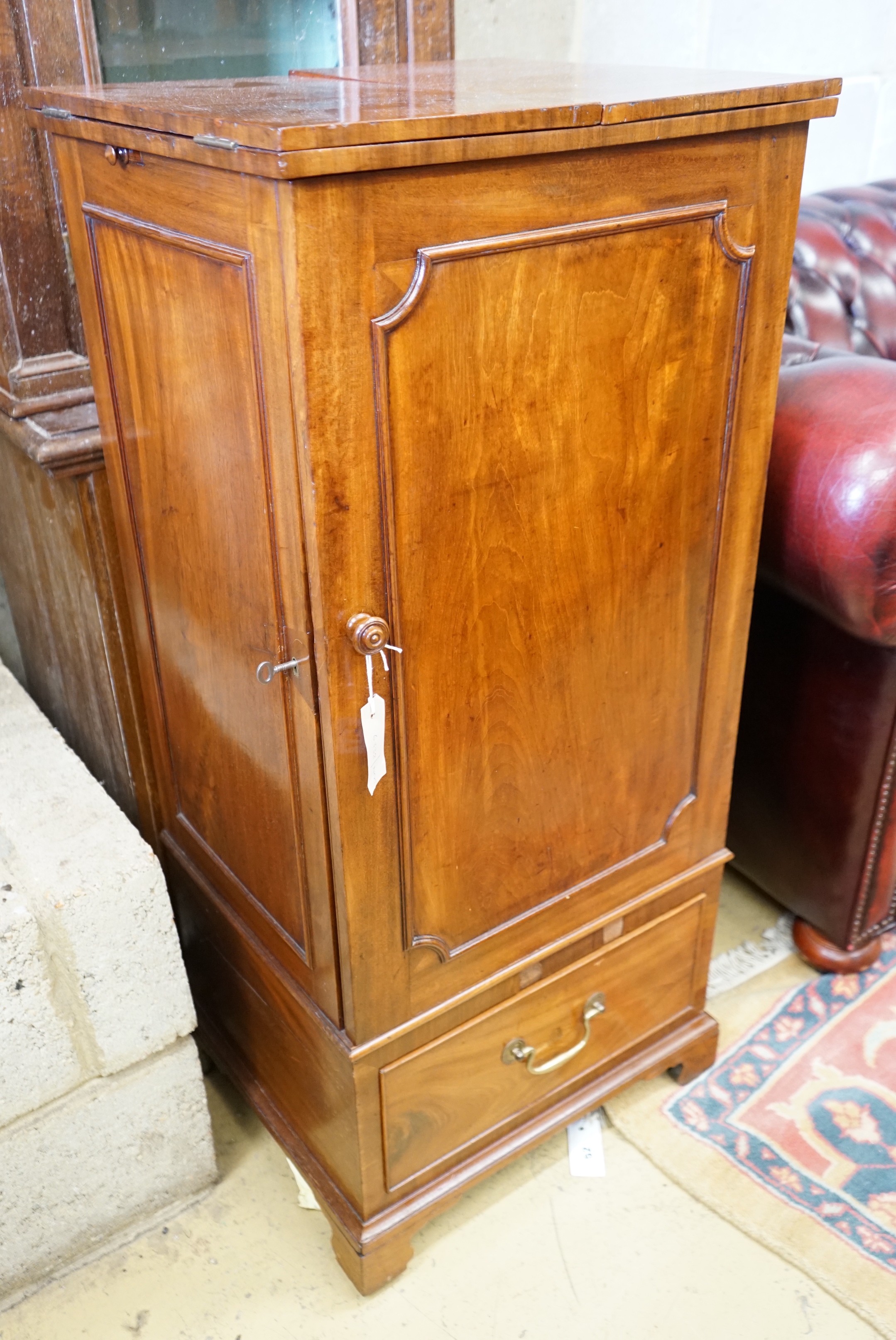 A Georgian style mahogany side cabinet with twin flap top, height 105cm together with a narrow Victorian bookcase, height 189cm                                                                                             