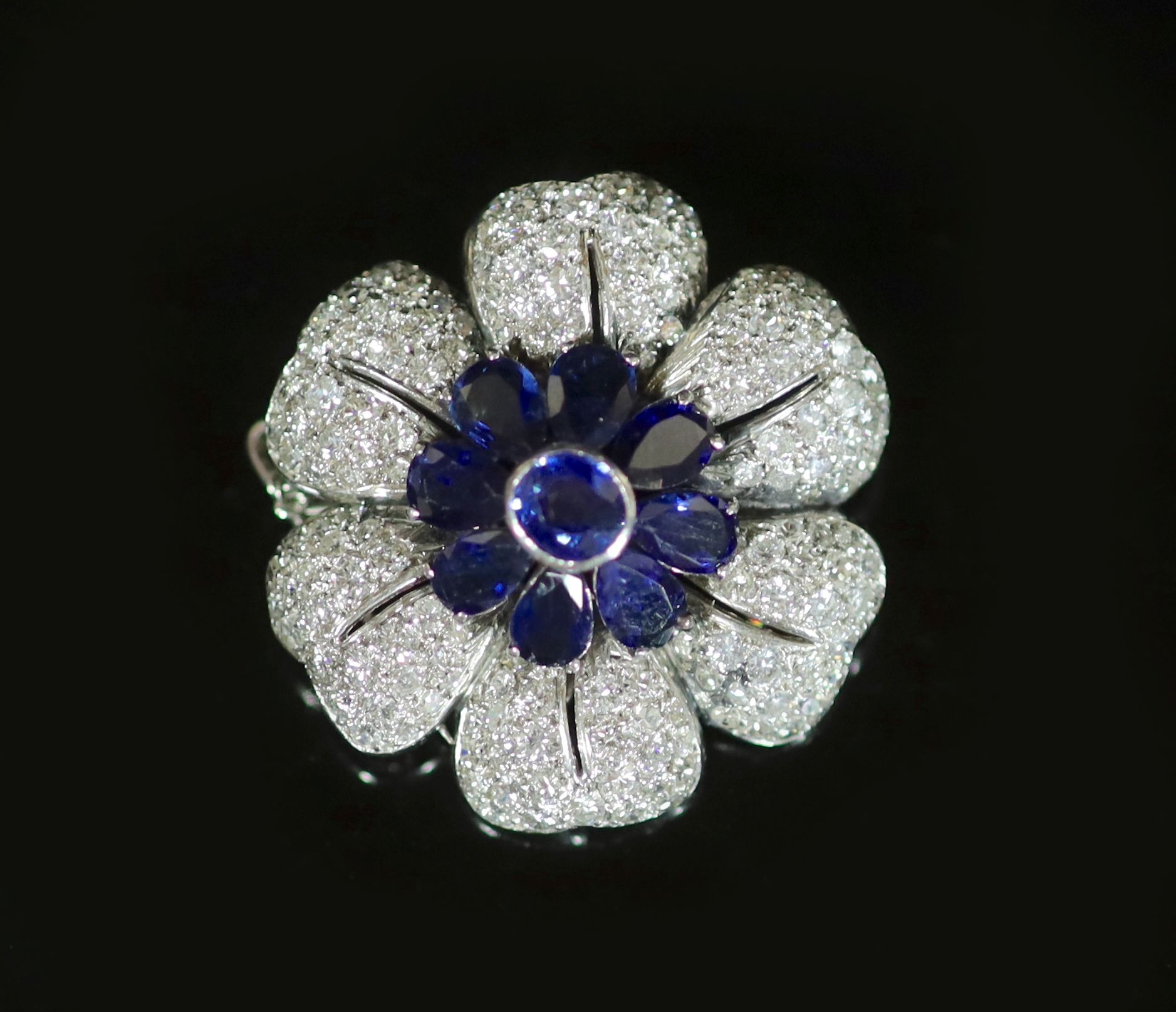 A platinum, sapphire and diamond floral design brooch,                                                                                                                                                                      