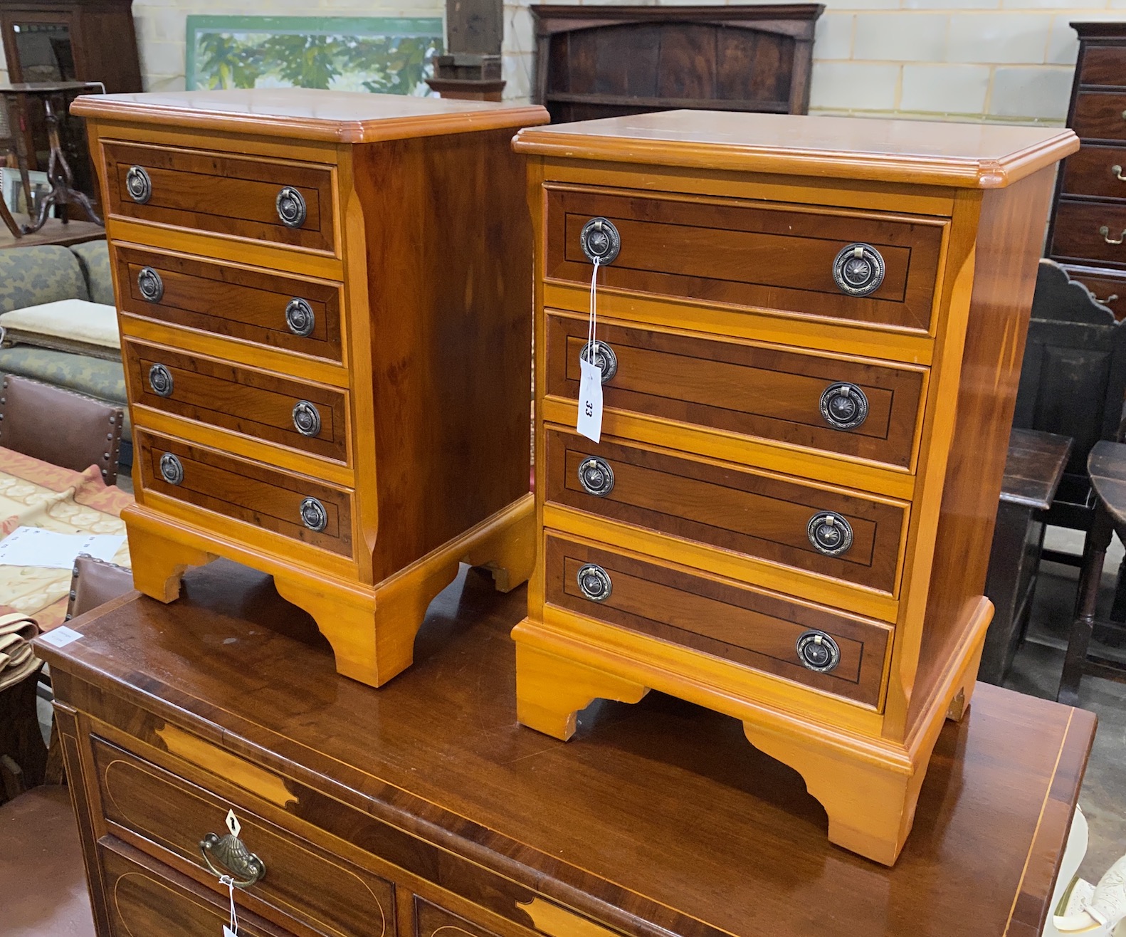 A pair of reproduction yew four drawer bedside chests, width 41cm, depth 32cm, height 60cm                                                                                                                                  