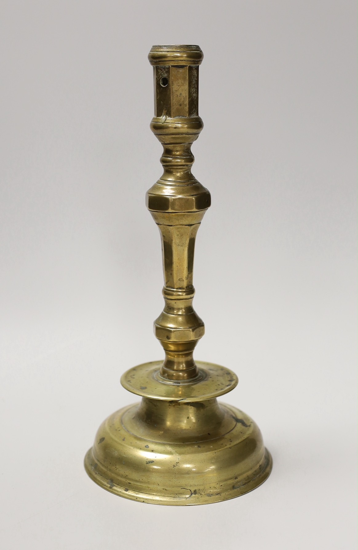 A 17th century continental brass candlestick. 28cm high                                                                                                                                                                     