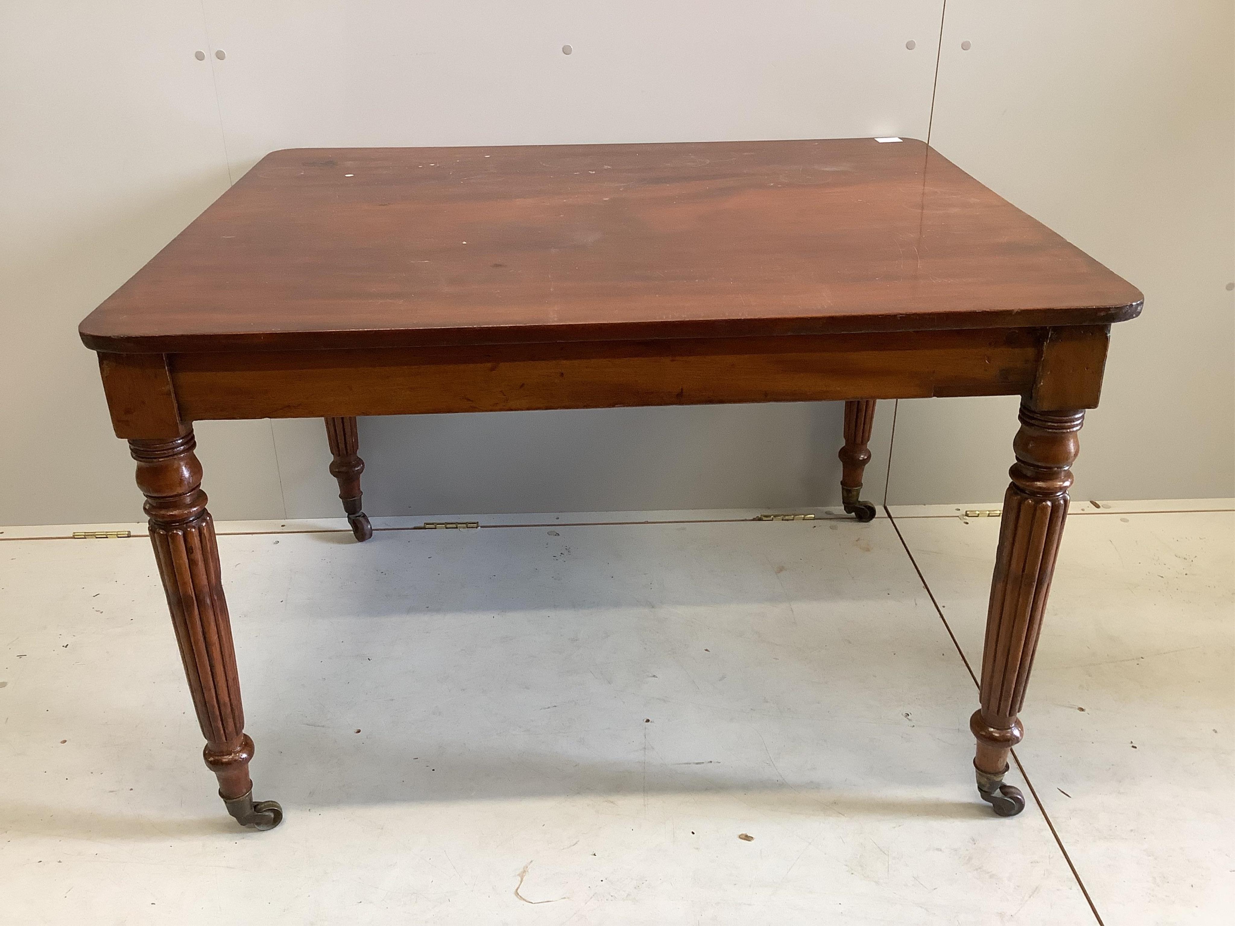 An early Victorian rectangular mahogany table, raised on fluted legs and brass castors, width 111cm, depth 90cm, height 74cm                                                                                                