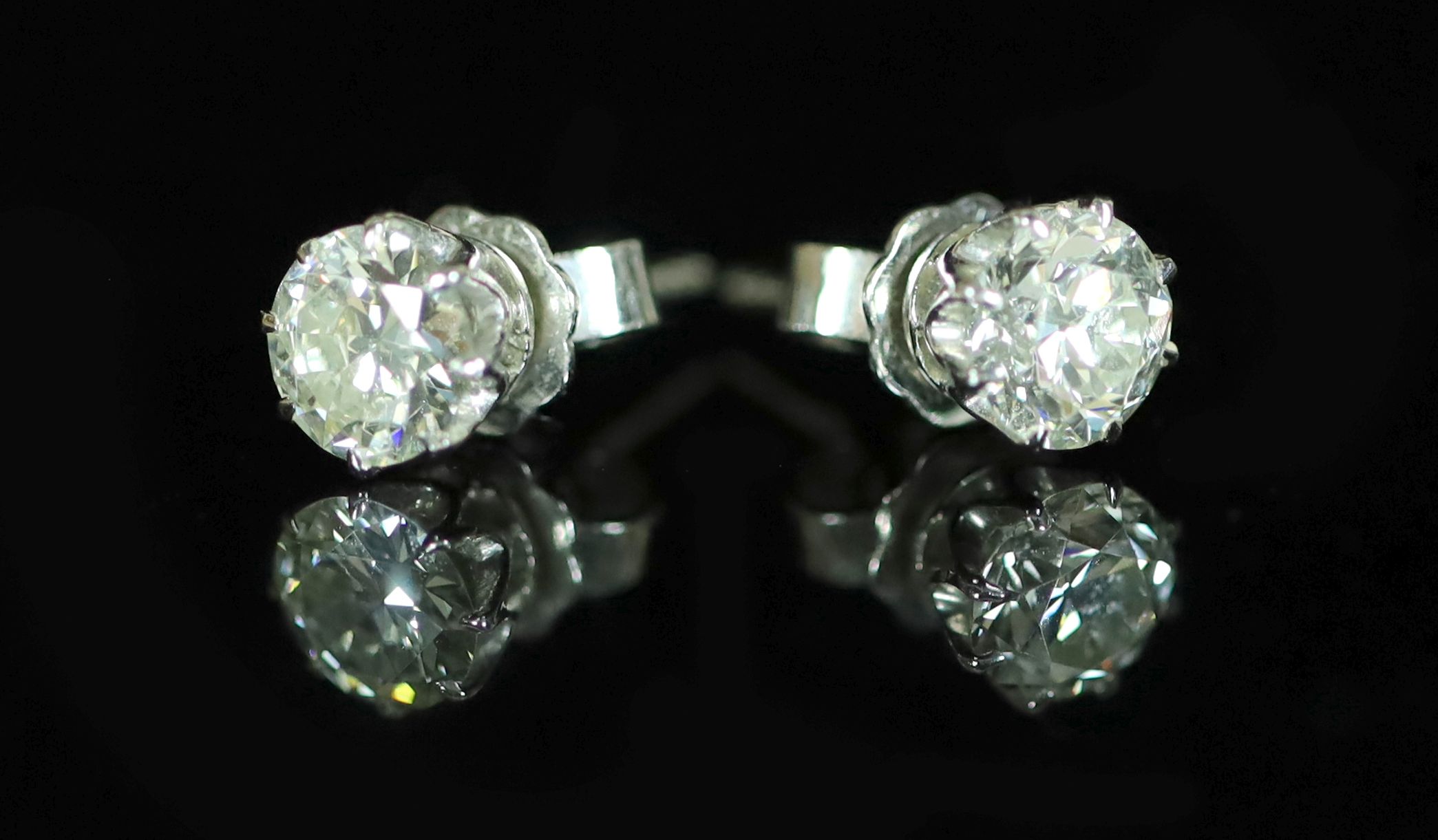 A pair of white gold and diamond stud earrings, the diamonds each approximately 0.75ct,                                                                                                                                     