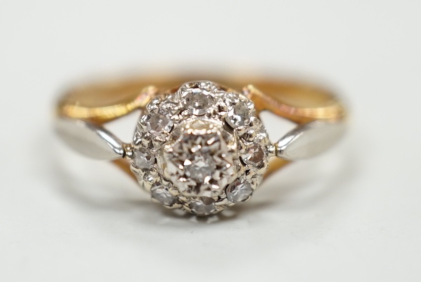 An 18ct and diamond cluster set ring, size K, gross weight 2.4 grams.                                                                                                                                                       