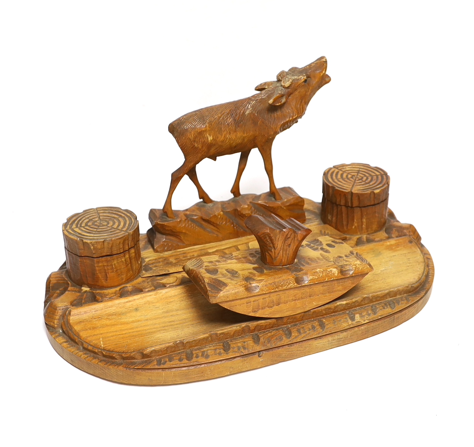 A Swiss carved wood desk set surmounted with a deer, 41cm wide                                                                                                                                                              