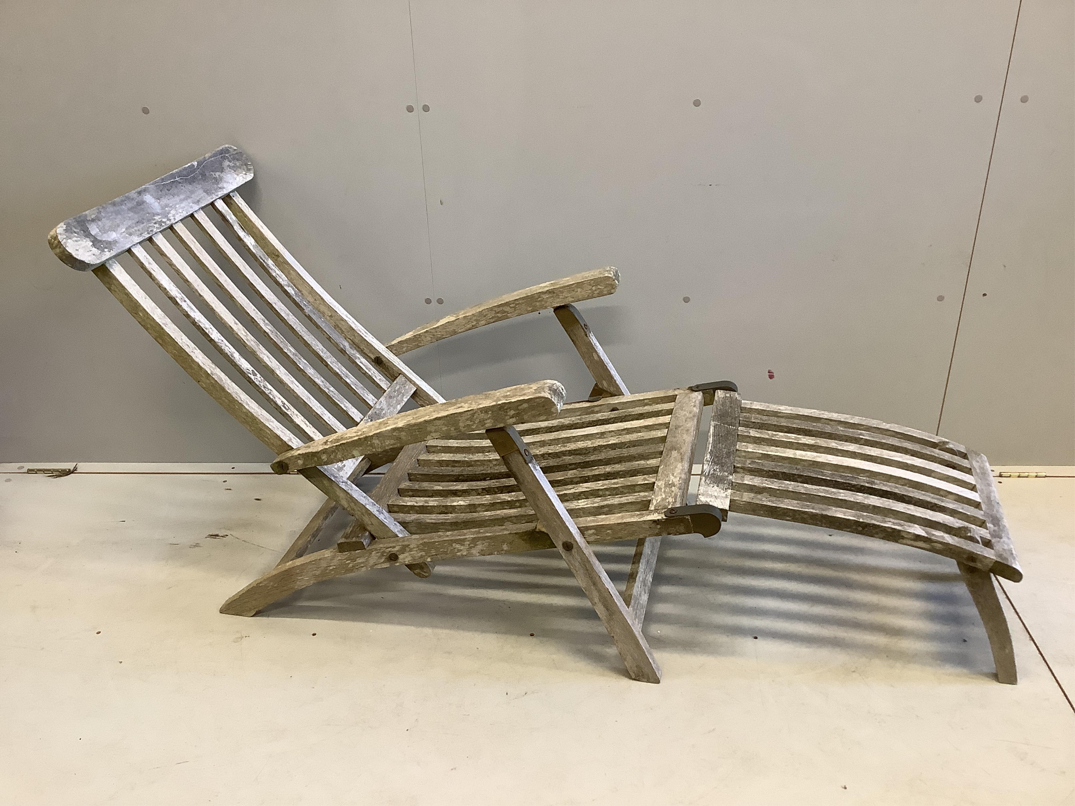 Two weathered teak steamer reclining garden chairs, height 86cm. Condition - fair-good                                                                                                                                      