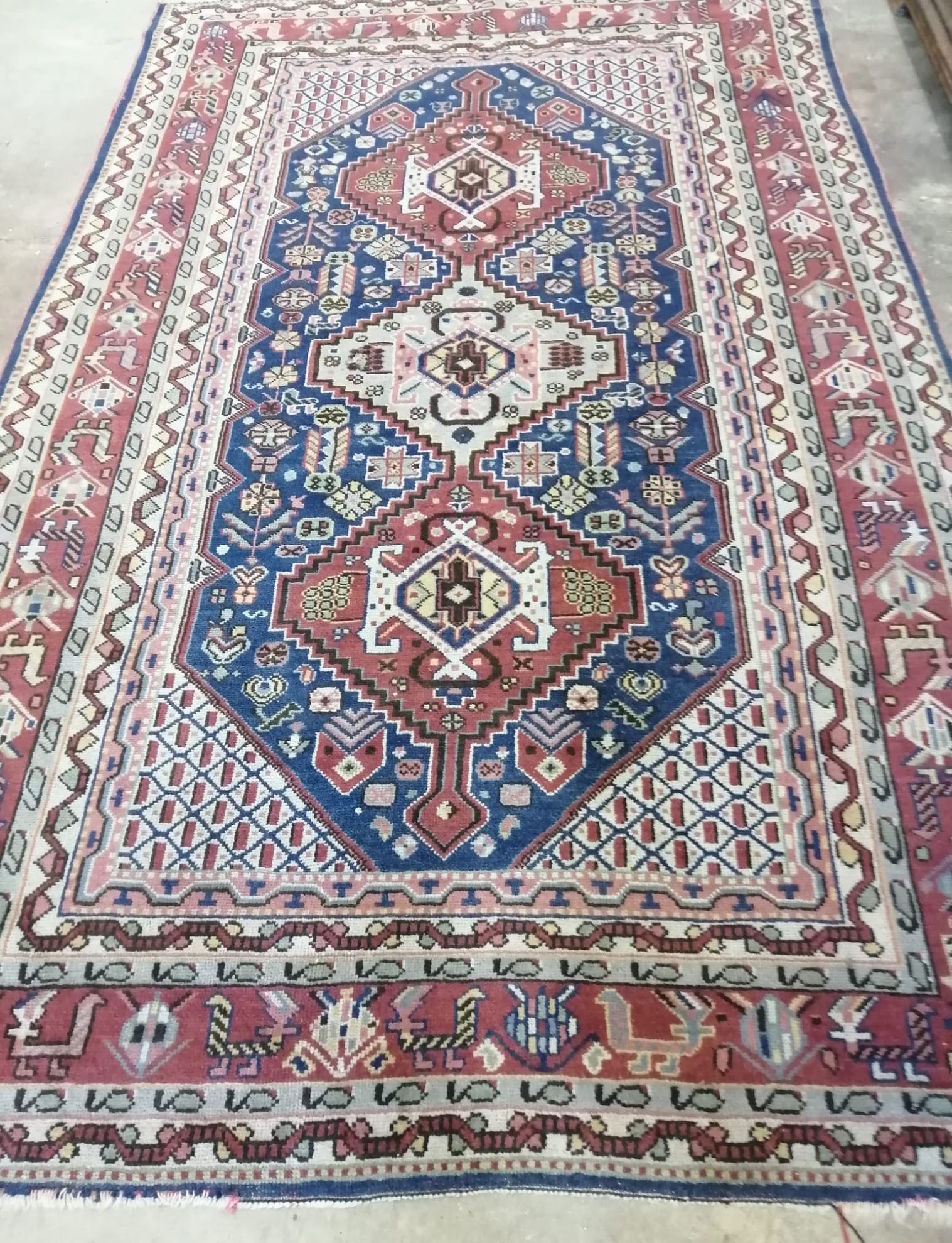 A Caucasian blue ground rug, 256 x 158cm *Please note the sale commences at 9am.                                                                                                                                            