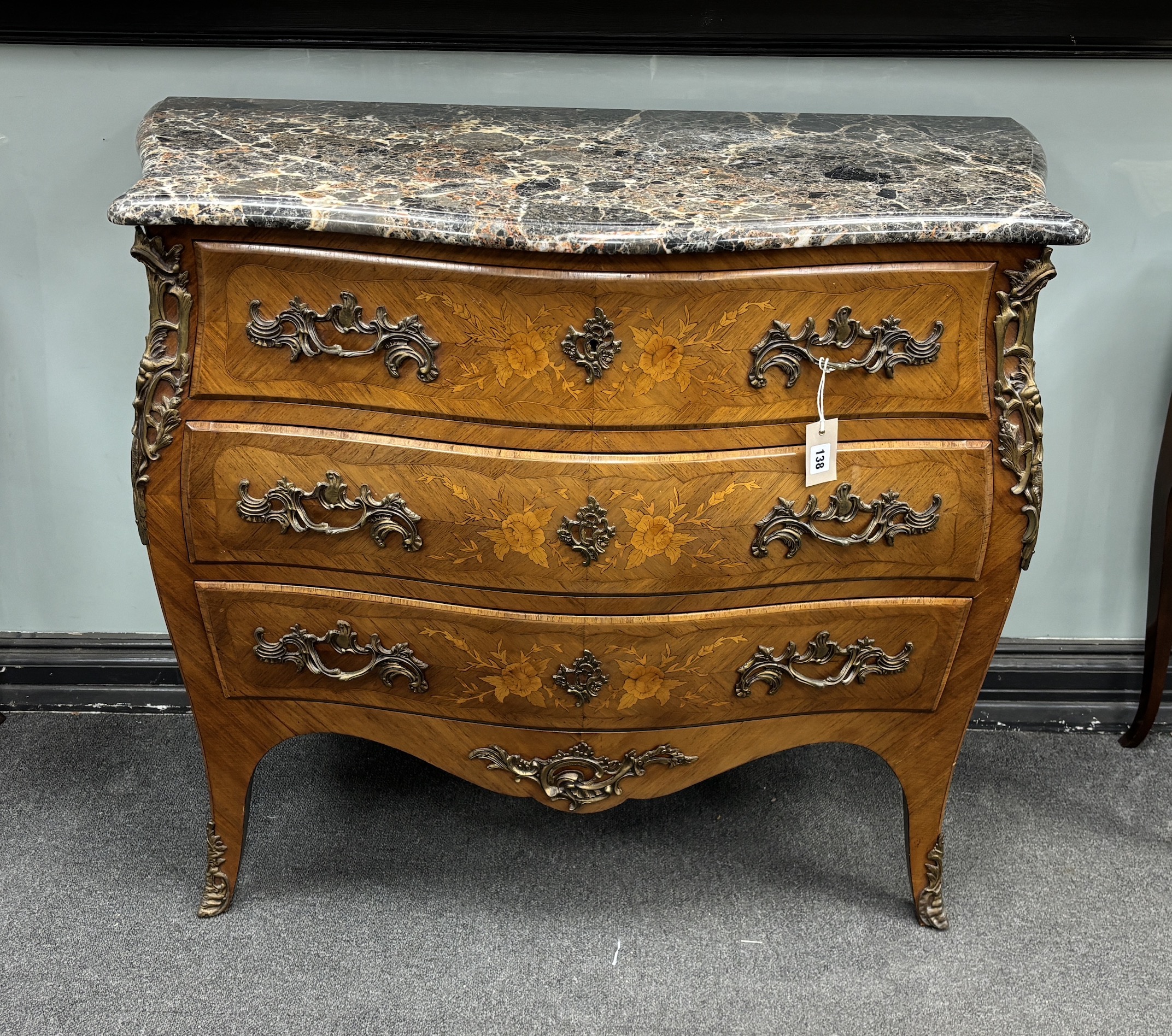A Louis XVI style gilt metal mounted inlaid kingwood marble topped serpentine bombe commode, width 106cm, depth 49cm, height 89cm                                                                                           