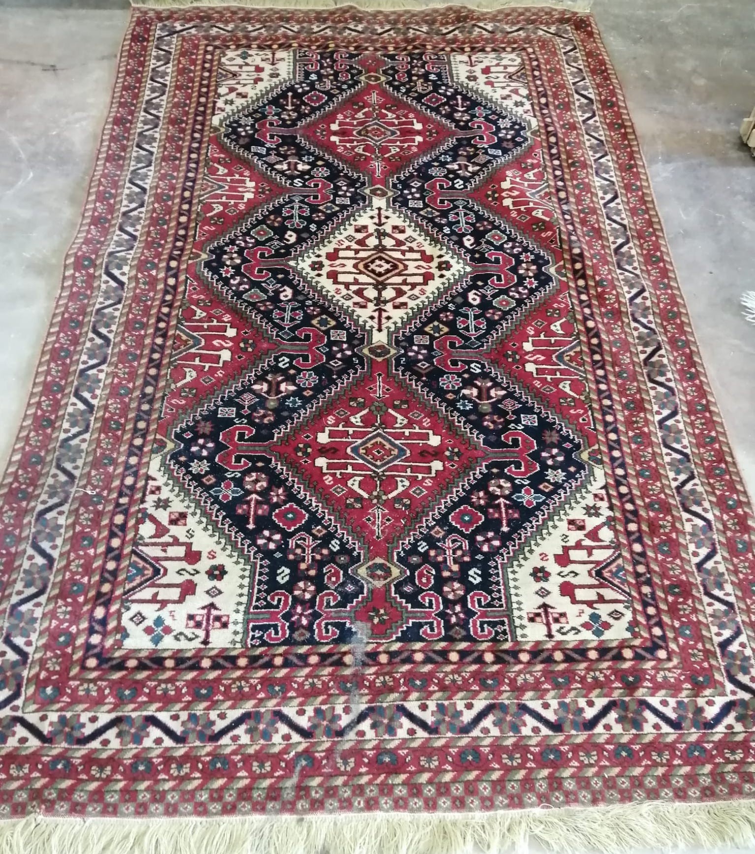 A Caucasian style red ground rug, 214 x 130cm *Please note the sale commences at 9am.                                                                                                                                       