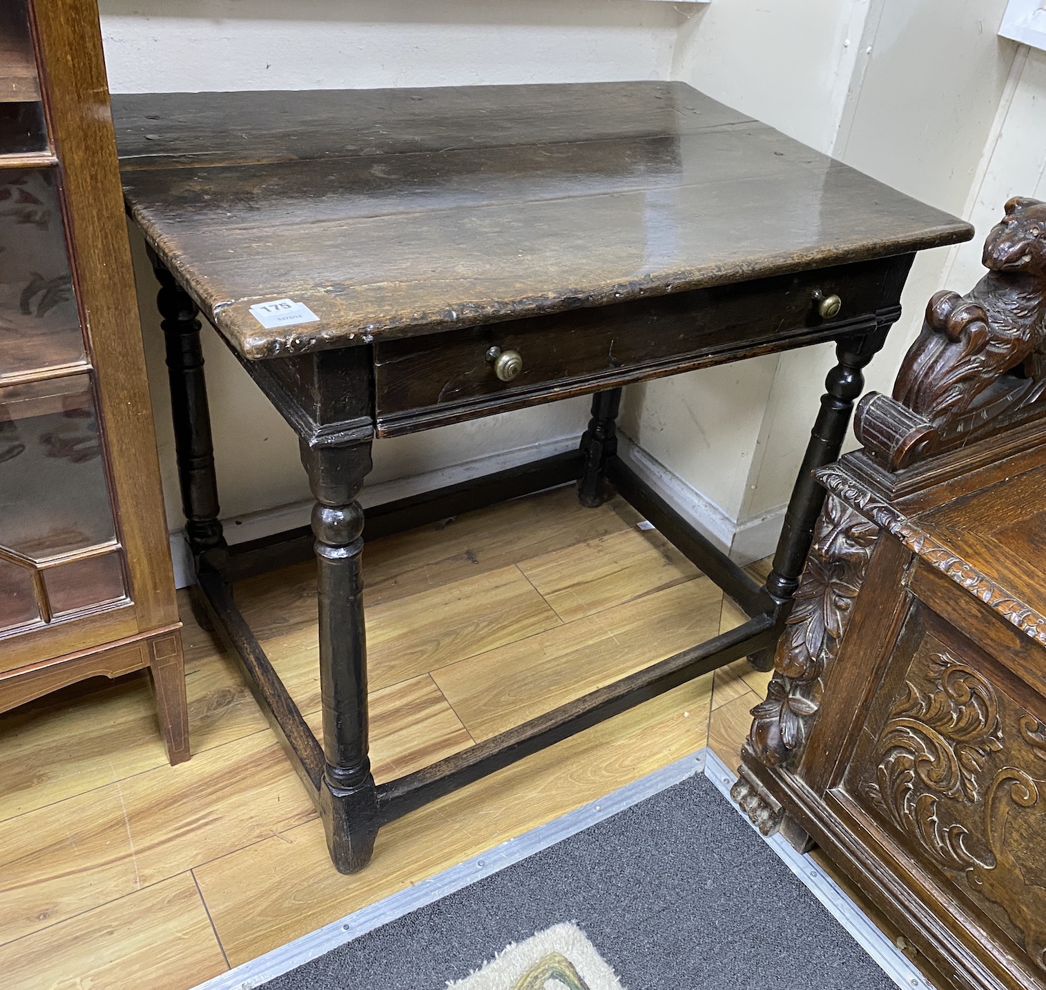 A Charles II oak side table, c.1680, with a drawer, the square and turned legs joined by stretchers, width 84cm, depth 56cm, height 72cm                                                                                    