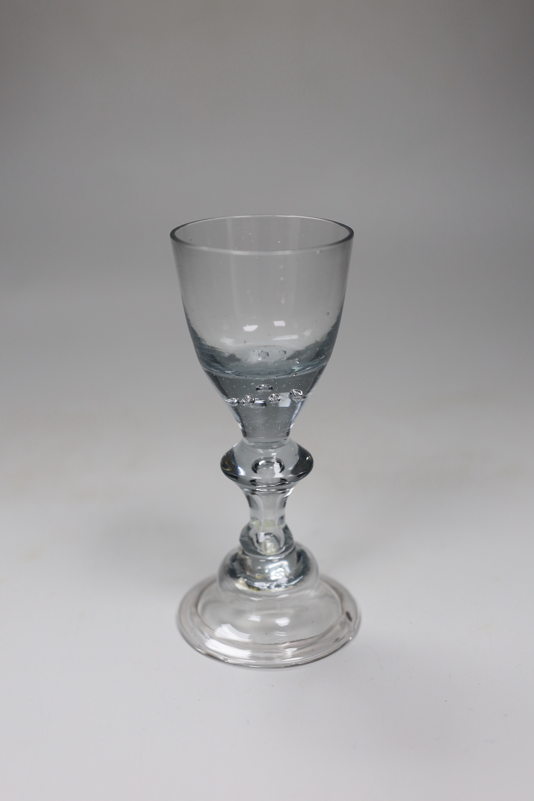 An unusual George II wine glass, bowl with air-tears, angular knop and domed foot, 13.5cm tall                                                                                                                              