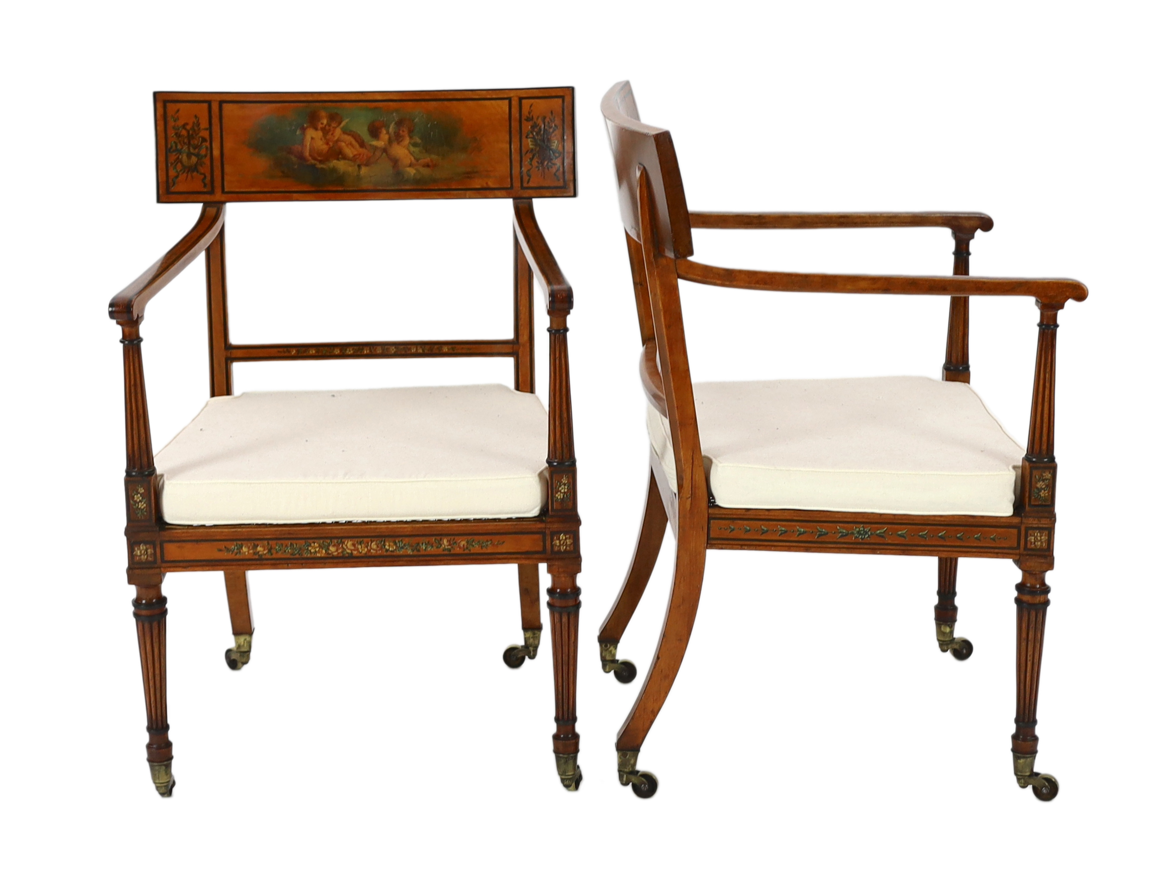 A pair of Edwardian Sheraton revival painted satinwood elbow chairs, 58cm wide, 57cm deep, 88cm high                                                                                                                        