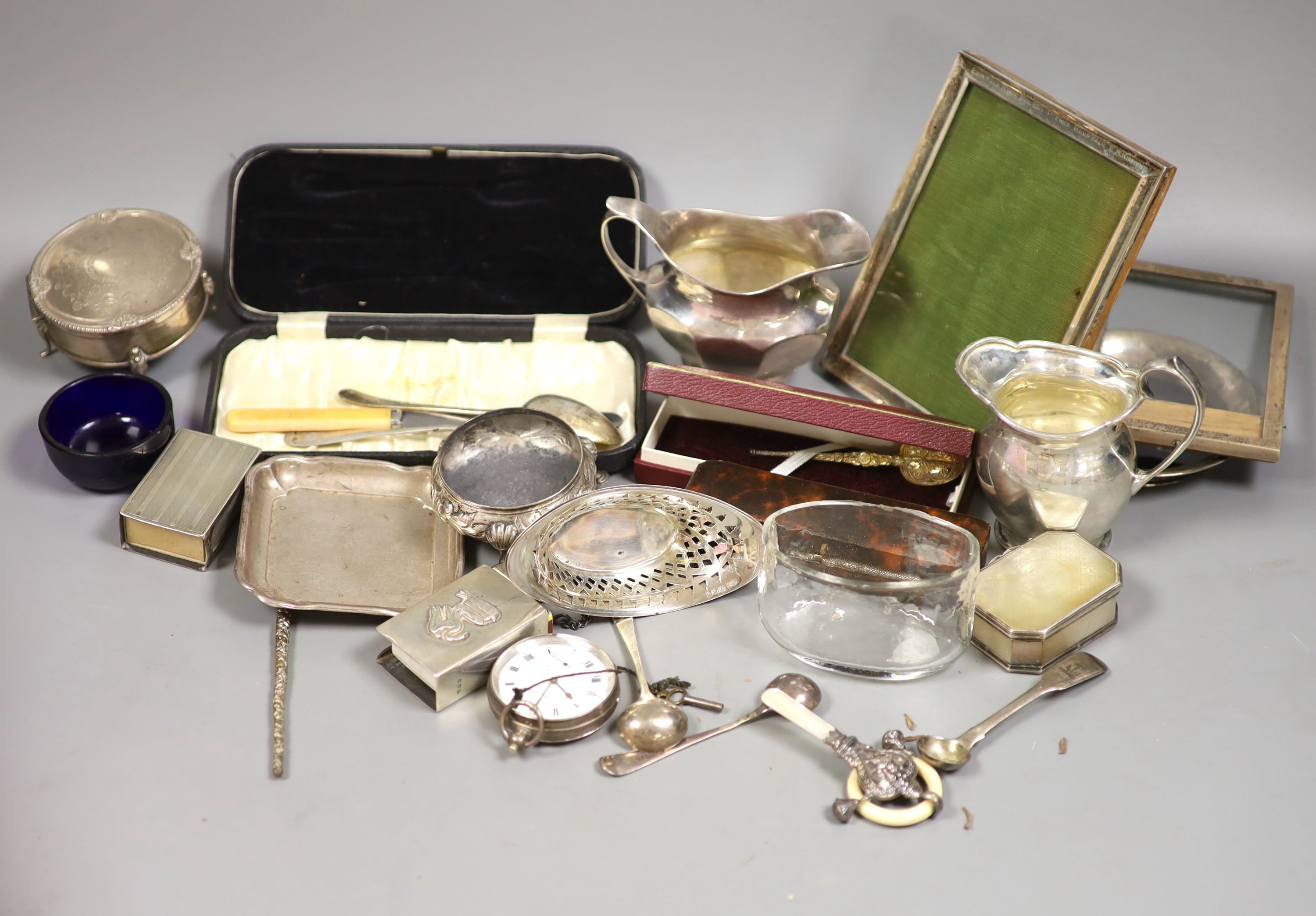 Sundry small silver including a silver trinket box, Victorian salt, two silver cream jugs, three silver dishes, 19th century mother of pearl snuff box, 6cm, pocket watch, photograph frames, etc.                          