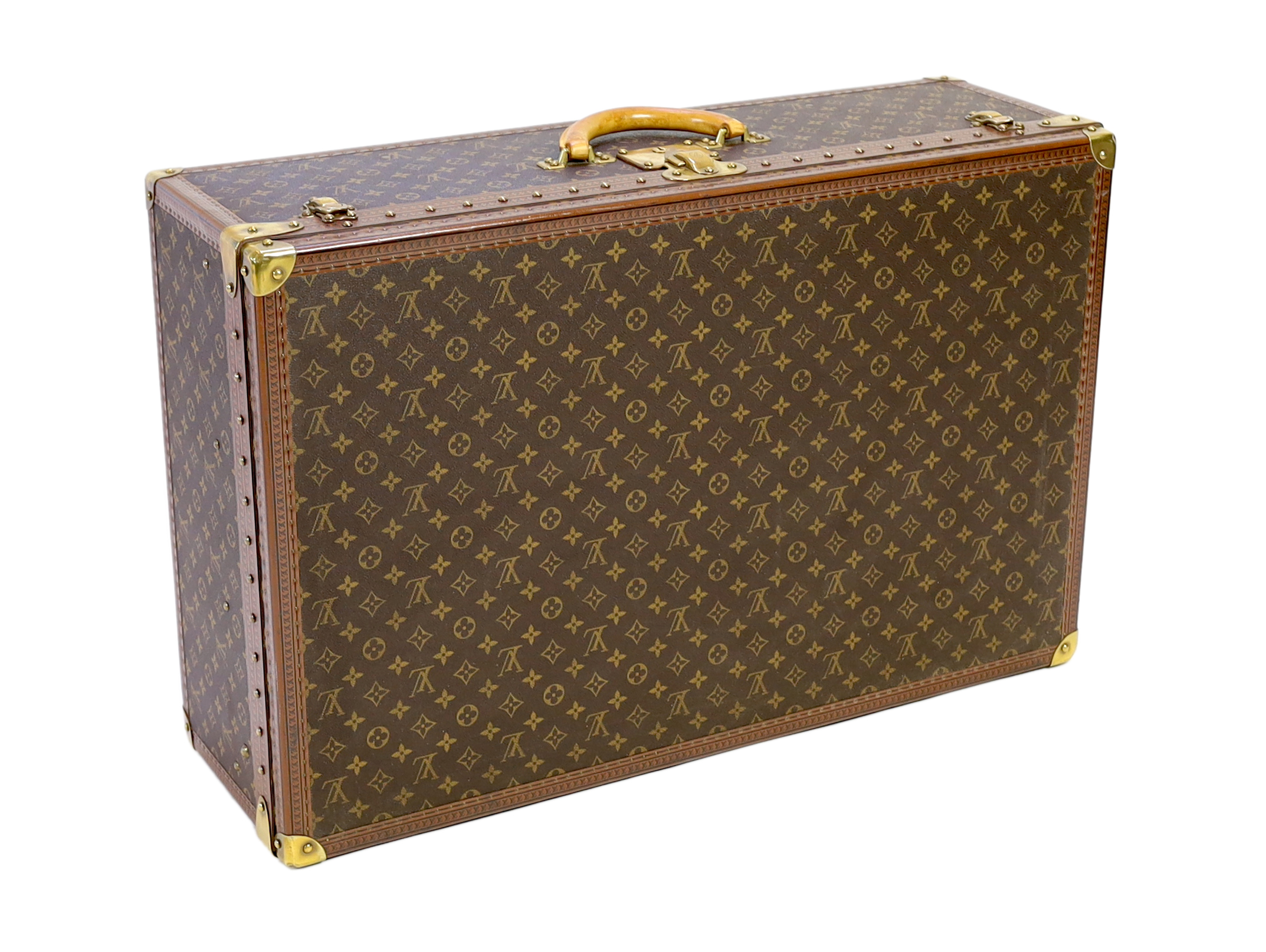 A Louis Vuitton monogrammed canvas and tan leather suitcase, 81cm wide, 26cm deep, 52cm high                                                                                                                                