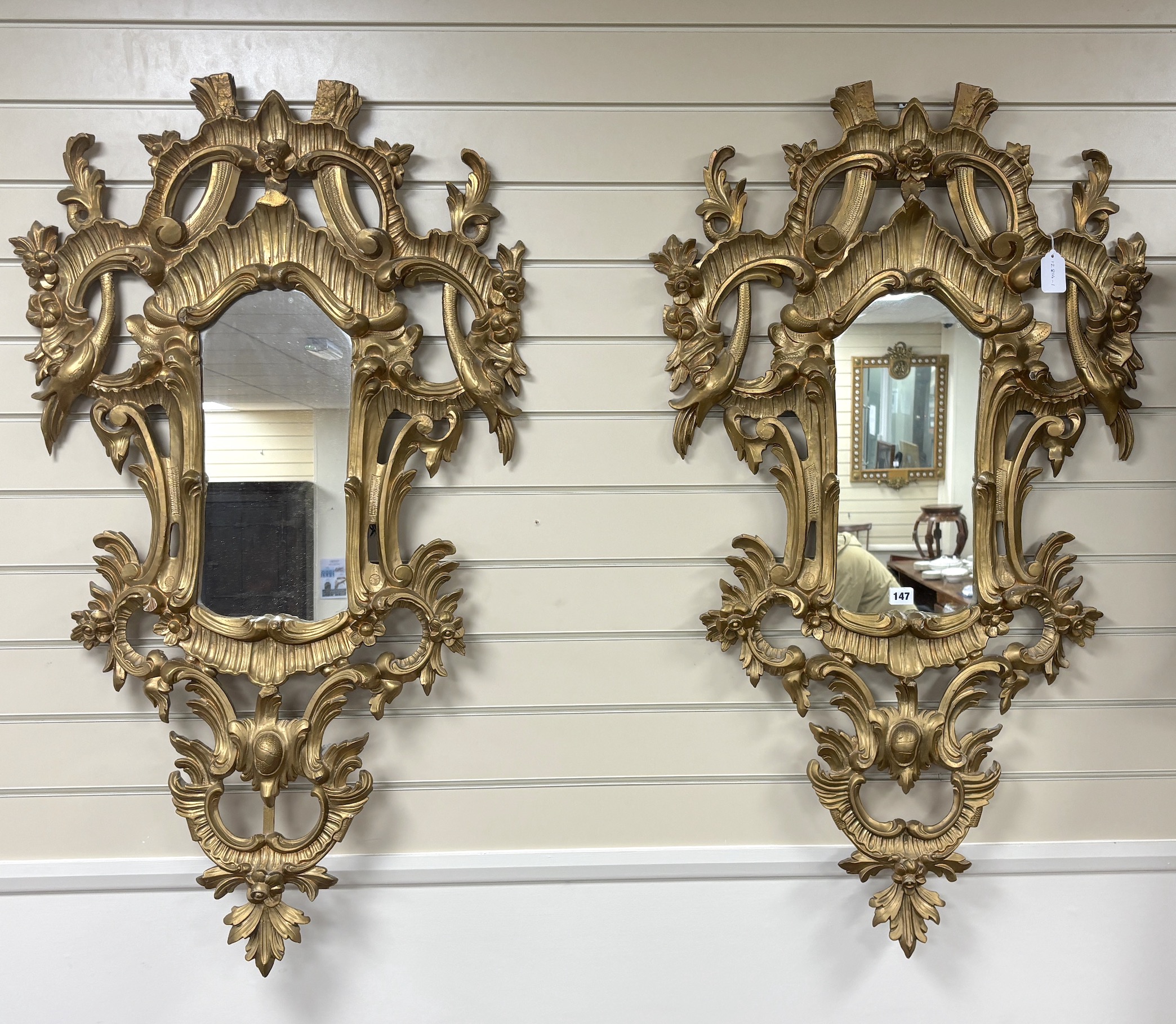 A pair of 18th century style carved giltwood wall mirrors, width 64cm, height 114cm                                                                                                                                         