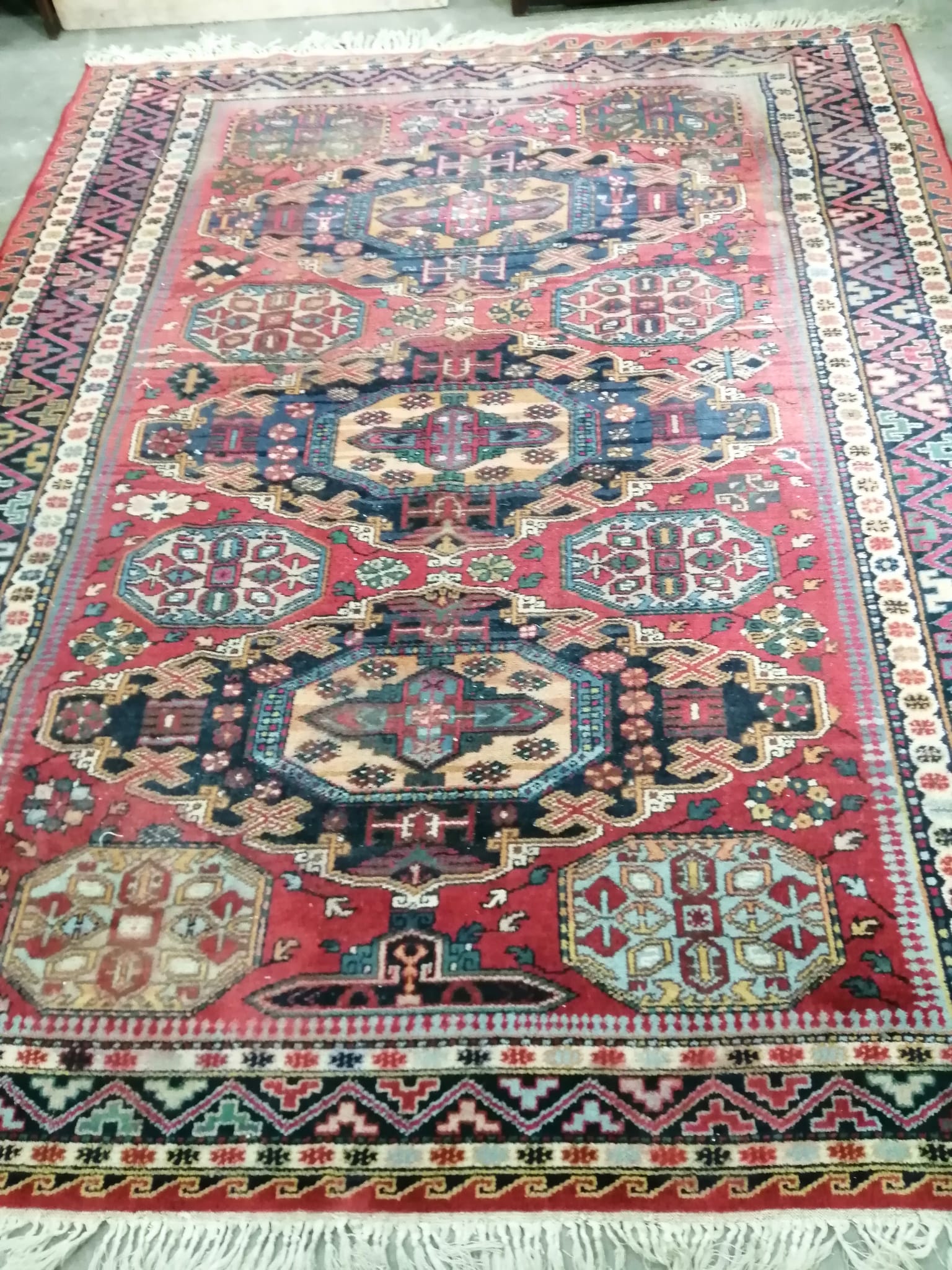 A Caucasian style red ground carpet, 260 x 206cm                                                                                                                                                                            
