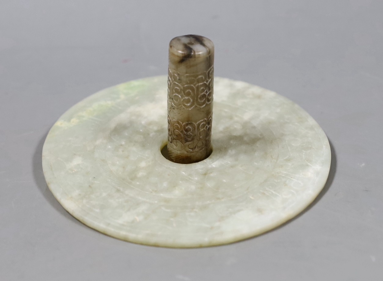 A Chinese archaistic white and black jade cylinder bead, 5.8 cm, boxed and a Chinese archaistic jade large bi disc, 13 cm diameter                                                                                          