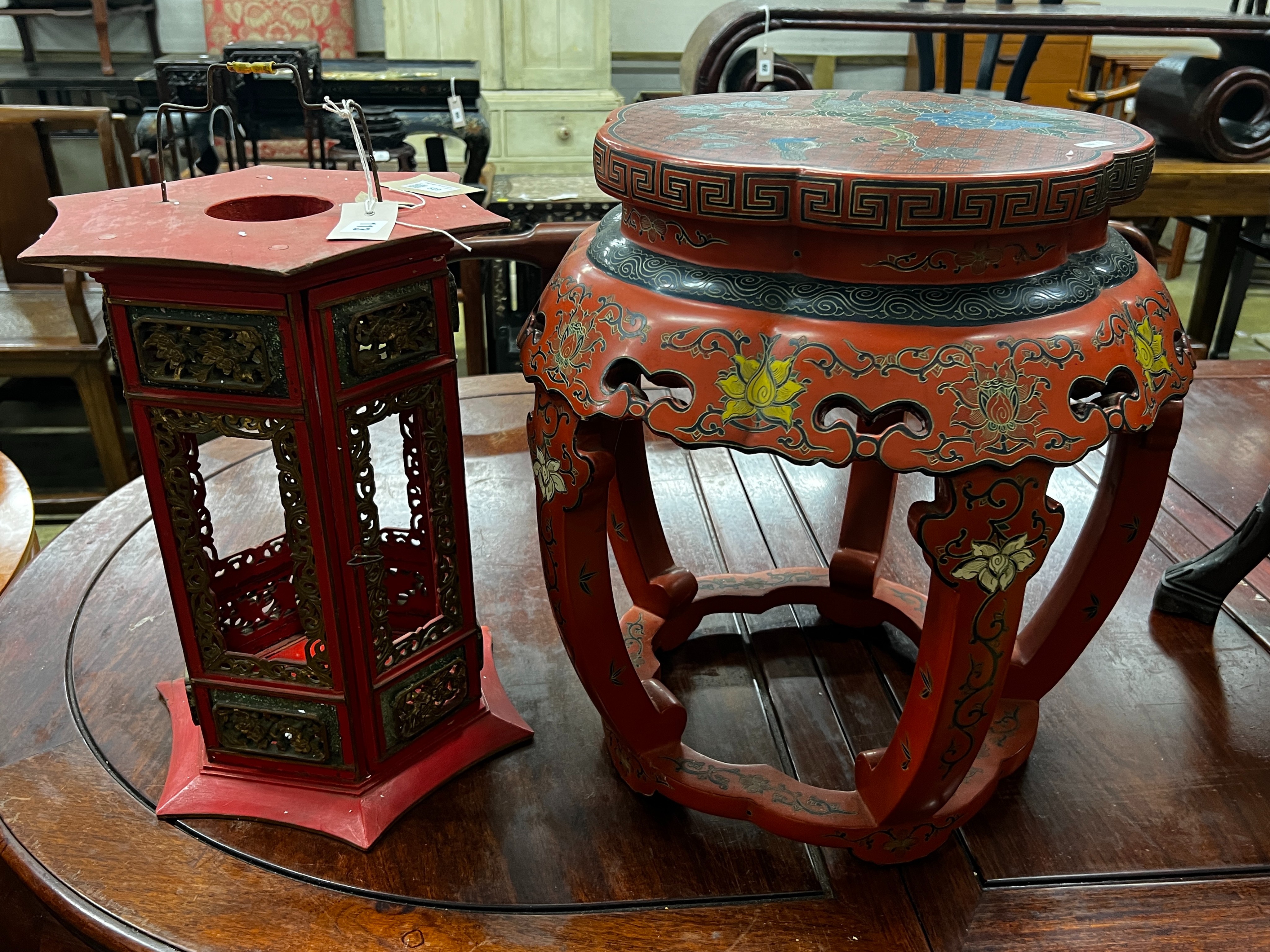 A Chinese red lacquer circular vase stand, diameter 44cm, height 47cm together with a similar Chinese red painted parcelgilt lantern, height 41cm                                                                           