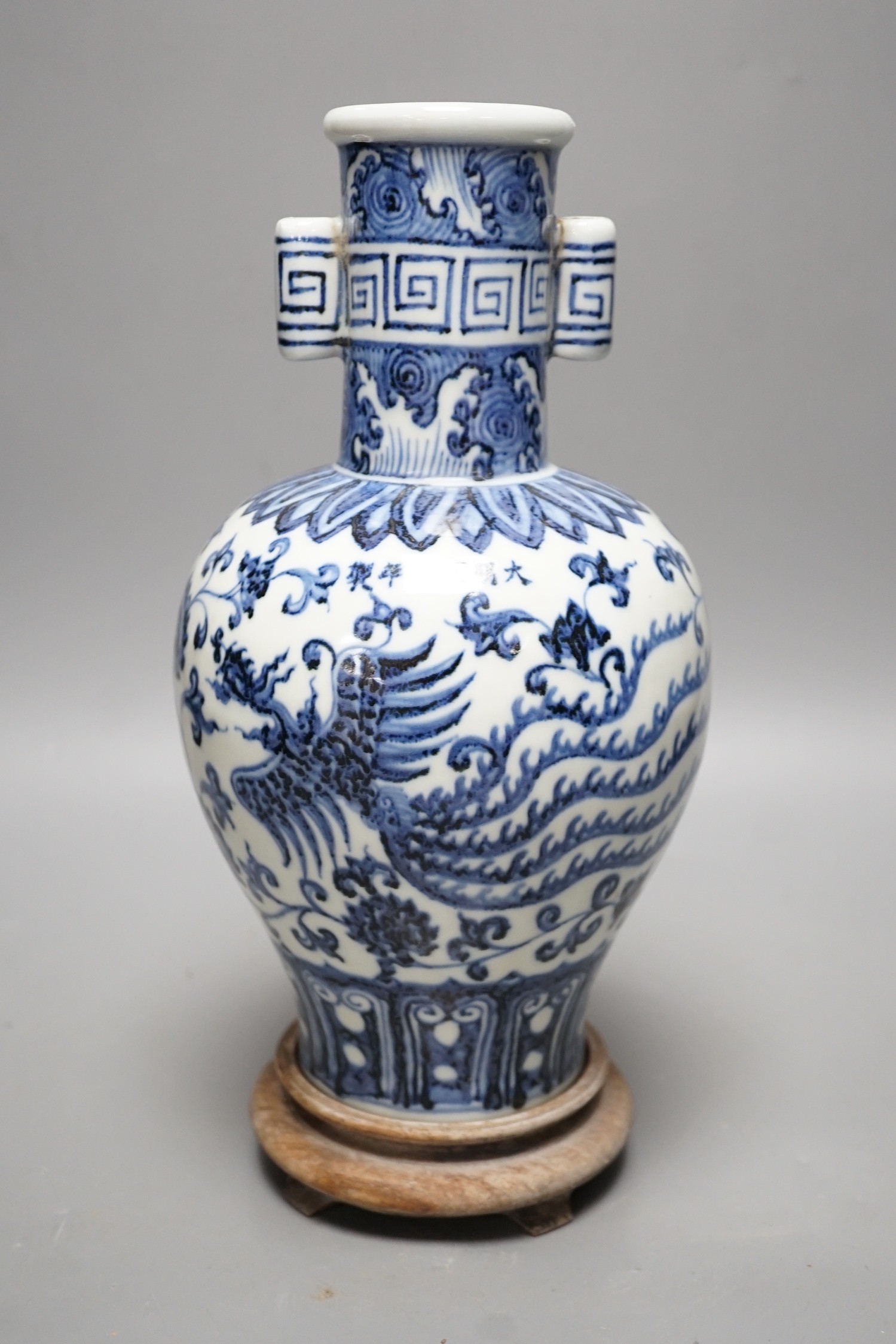 A Chinese blue and white vase on stand, 34cms high                                                                                                                                                                          
