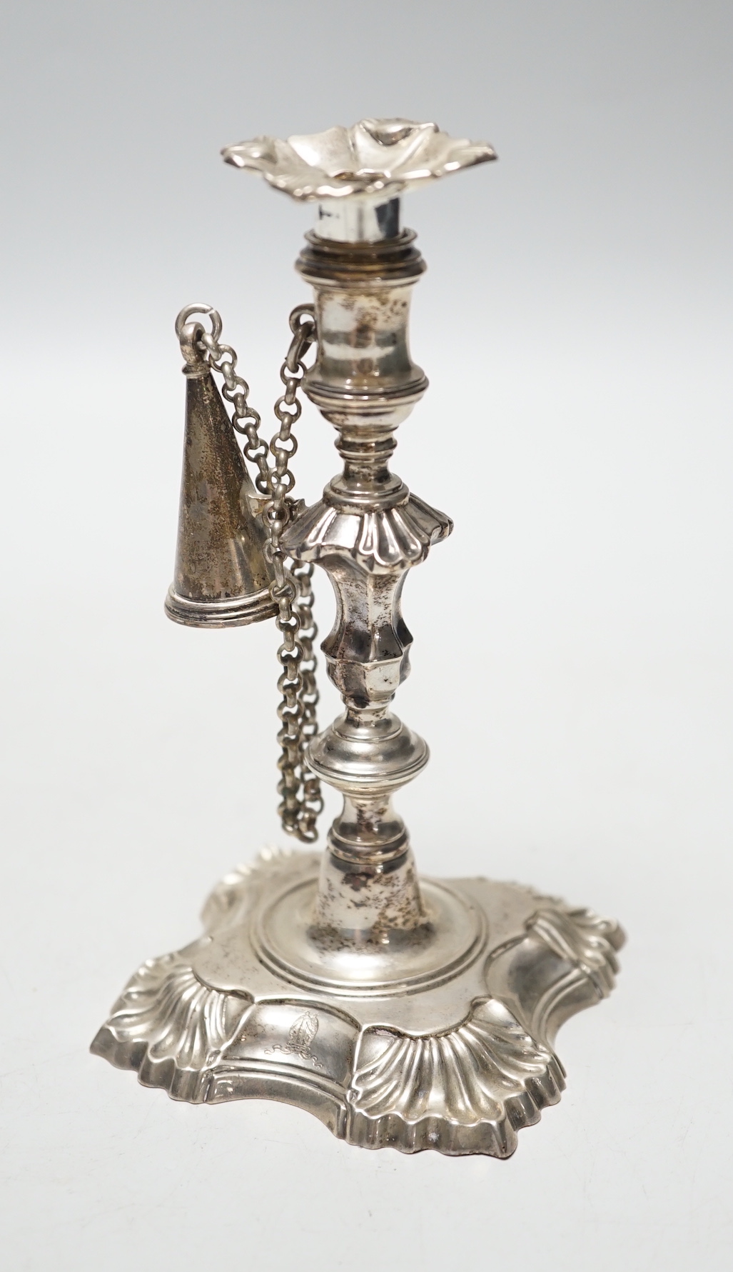 A George II cast silver taper stick, William Gould, London, 1751, with later George IV extinguisher and unmarked sconce, 13.3cm, 6.7oz.                                                                                     