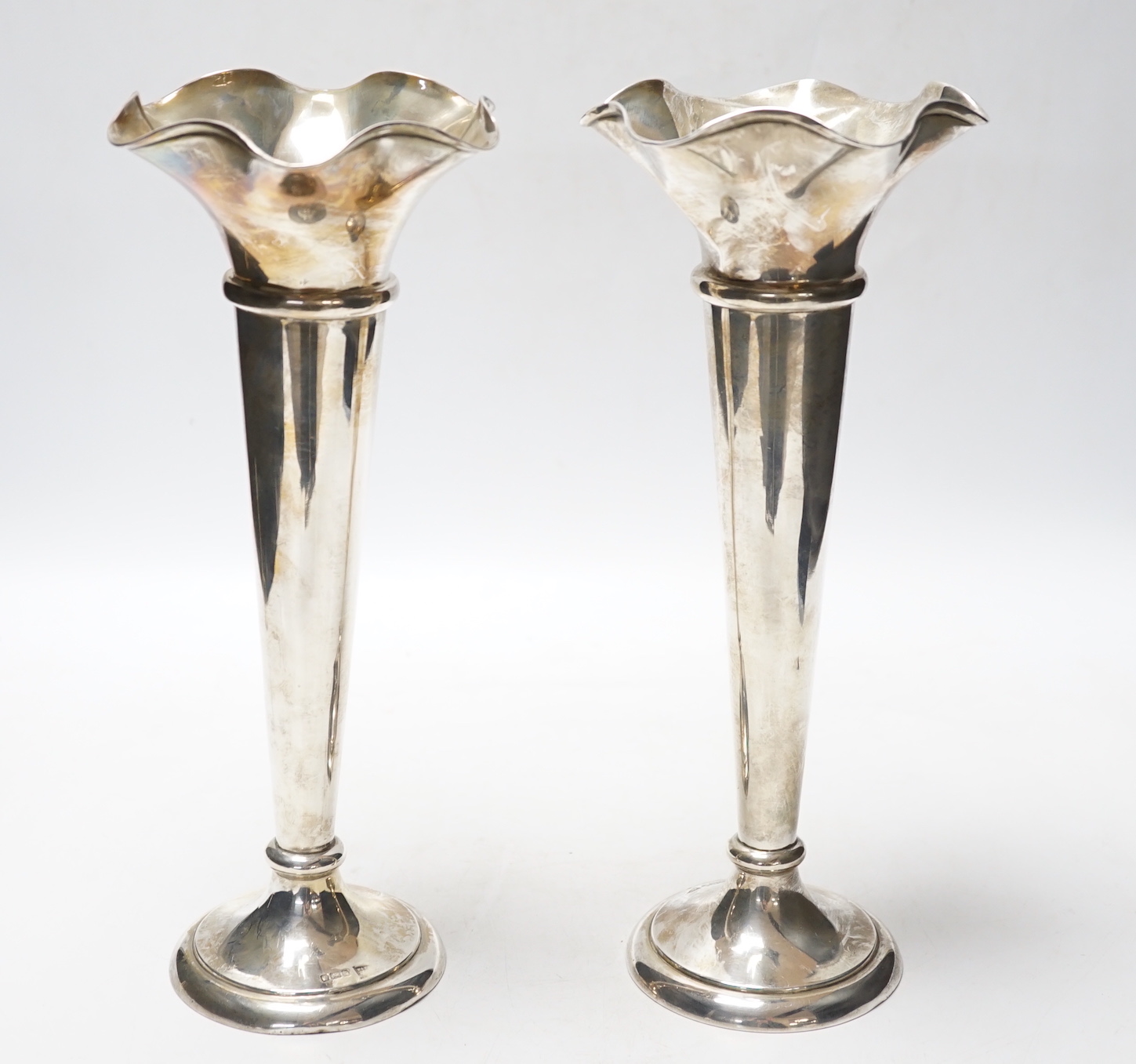 A pair of George V silver spill vases, with wavy rims, Walker & Hall, Sheffield, 1911, 27.1cm, weighted.                                                                                                                    