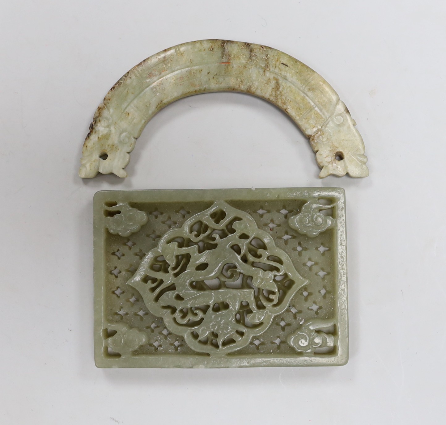 A Chinese jade rectangular plaque and a jade huang pendant (2) Width 9cm.                                                                                                                                                   