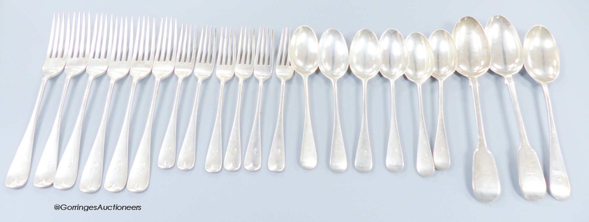 A part canteen of George V silver Hanovarian pattern flatware, comprising nineteen items, Wakely & Wheeler, London, 1911 and two earlier silver fiddle pattern tablespoons, 41.5oz.                                         