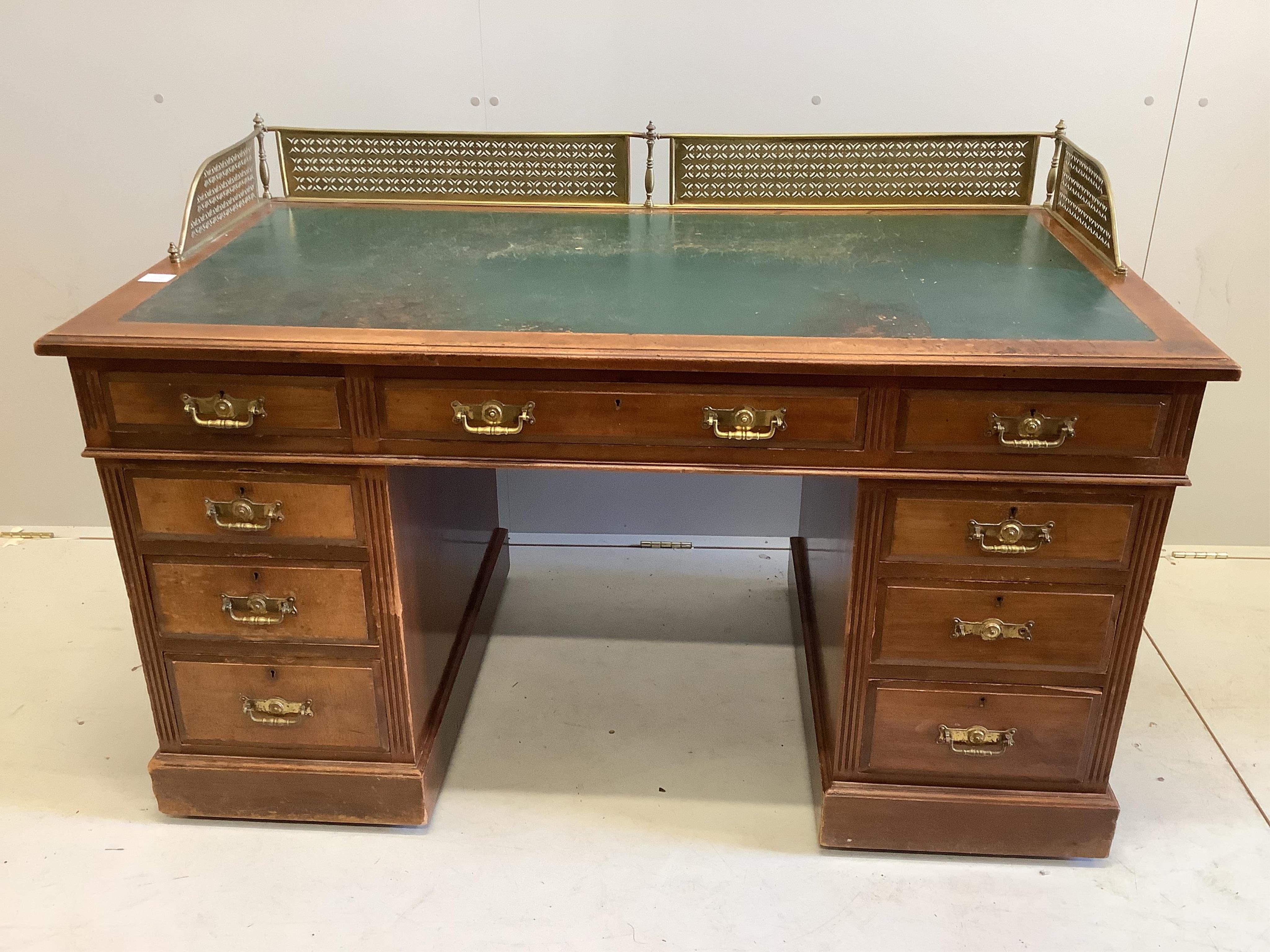 A late Victorian mahogany pedestal desk, fitted with pierced brass gallery, width 138cm, depth 73cm, height 90cm                                                                                                            