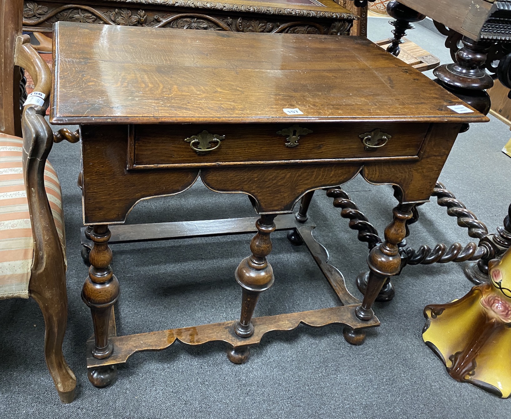 A William and Mary oak side table, c.1690, with a drawer and arcaded gallery, the five upturned vase shaped legs joined by peripheral stretchers, width 80cm, depth 49cm, height 71cm                                       