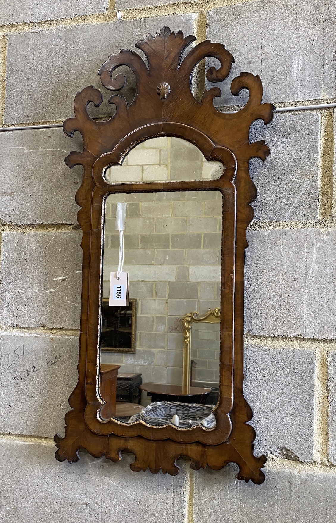 An 18th century style walnut fret cut wall mirror, width 43cm, height 90cm                                                                                                                                                  