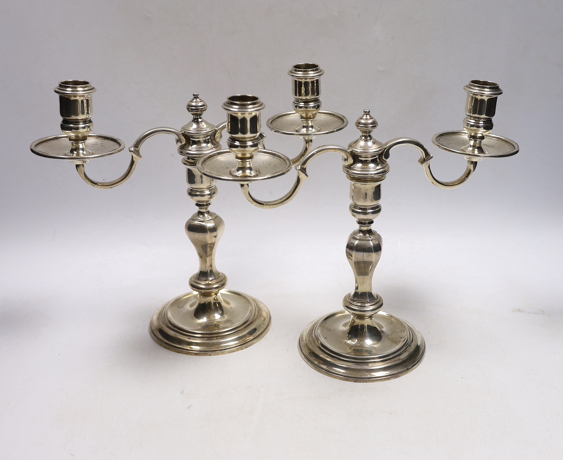 A pair of George VI silver two branch, two light candelabra, Thomas Ducrow & Sons, Birmingham, 1945, height 20.8cm, 44.6oz.                                                                                                 