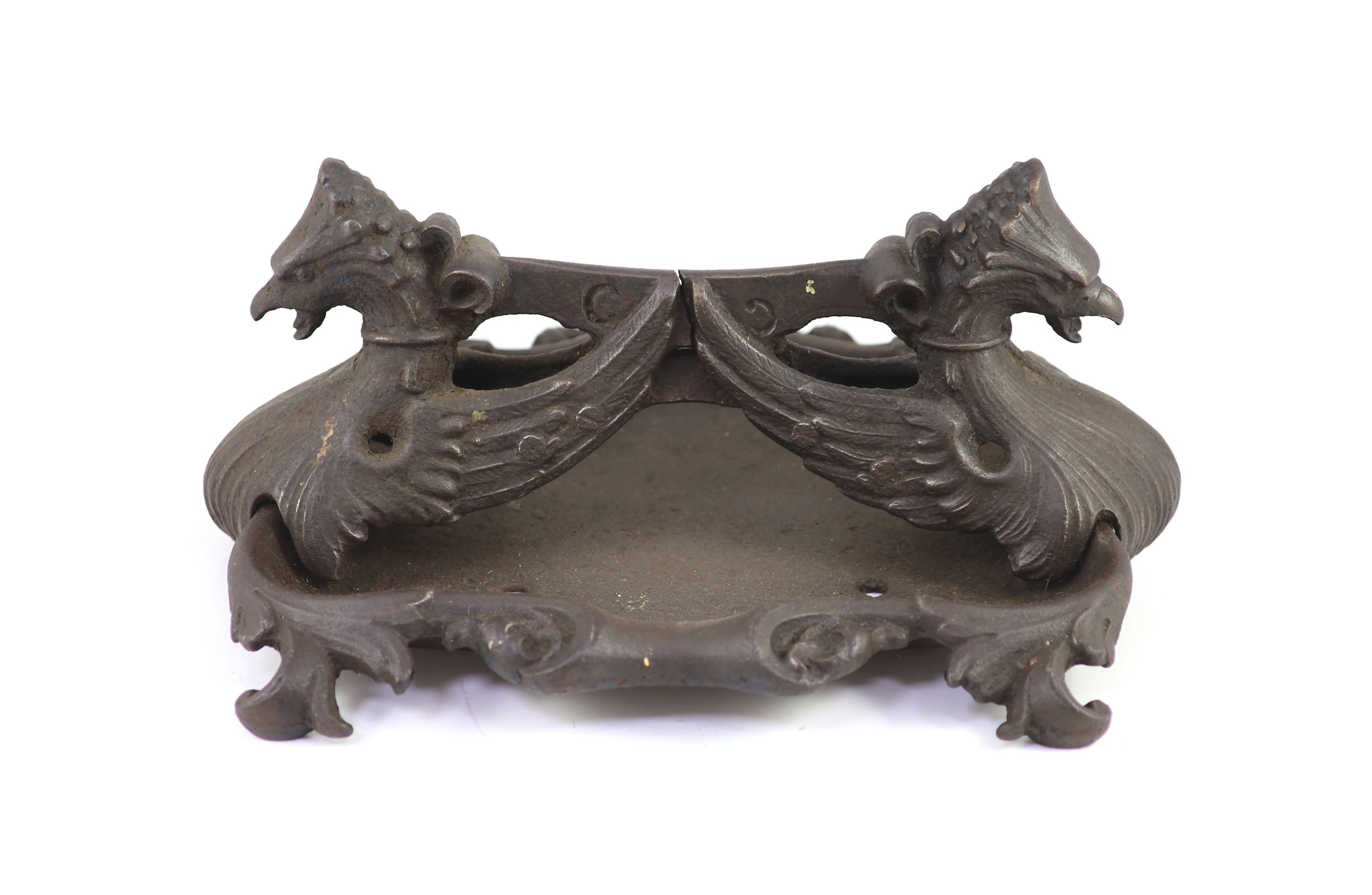 A Coalbrookdale cast iron 'griffin' boot scraper H 19cm. W 44cm. D 37cm.                                                                                                                                                    