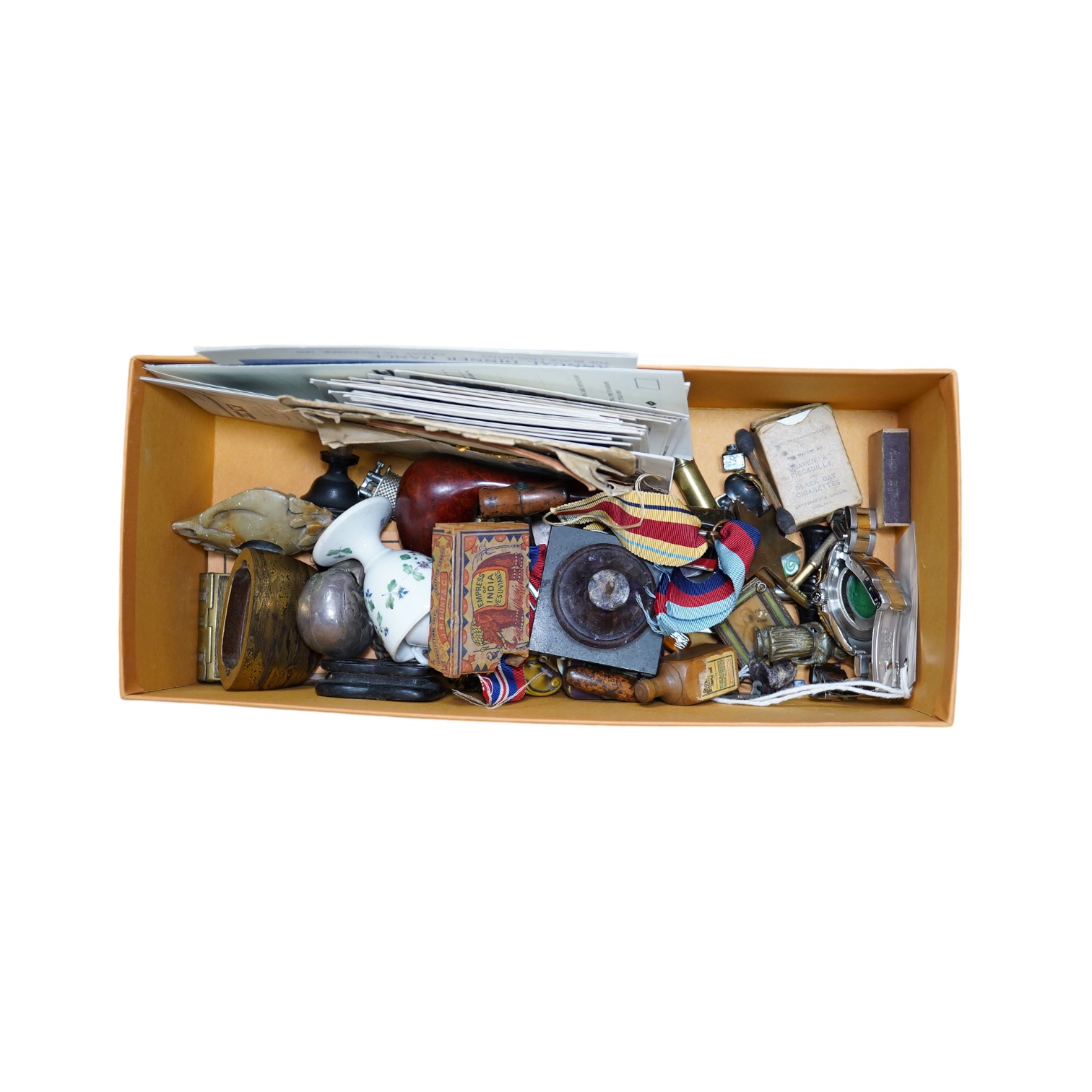 A box of assorted curiosities including vesta cases, one in the form of a skull, medals, section of Japanese inro and miniatures. Condition - varies                                                                        