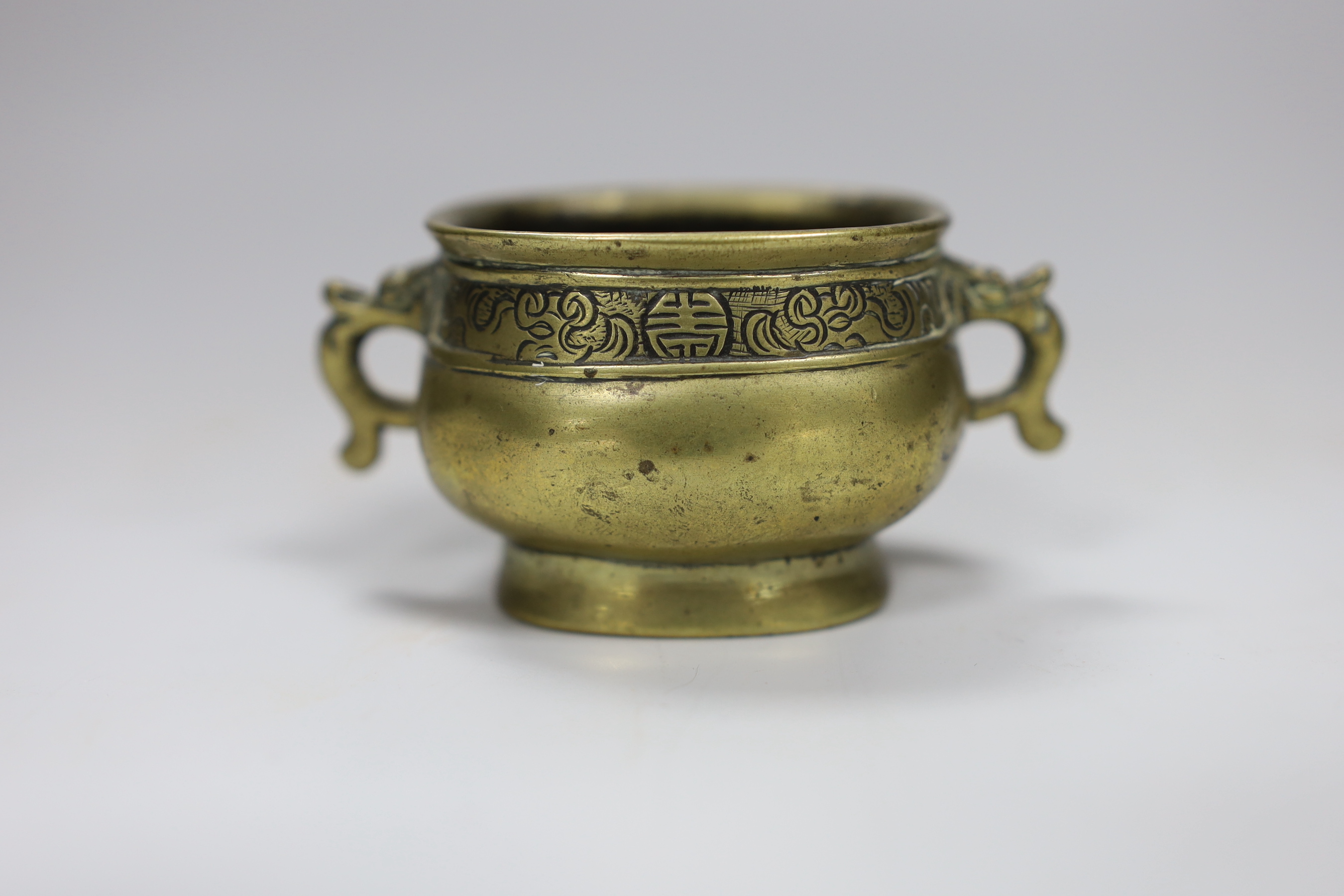 A Chinese miniature bronze censer, fanggui, Xuande six character mark, 18th/19th century, 8cm wide. Purchased in 1965 in Tsingtao on ship called 'Rushpool', Company: 'Sir Robert Ropner' on Chinese charter taking arms to 