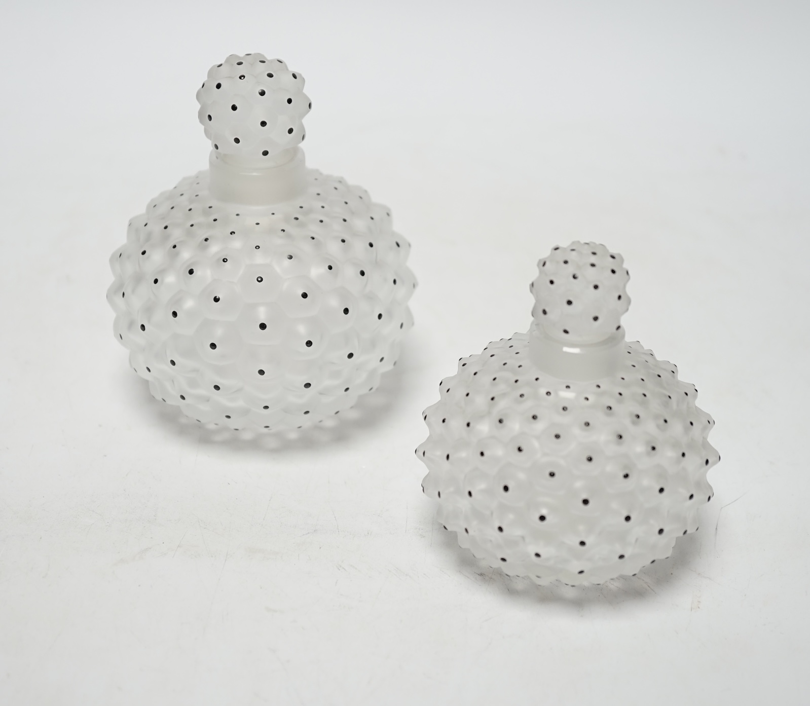 Two Lalique graduated cactus pattern glass scent bottles and stoppers, one with label to the base, largest 12cm high                                                                                                        