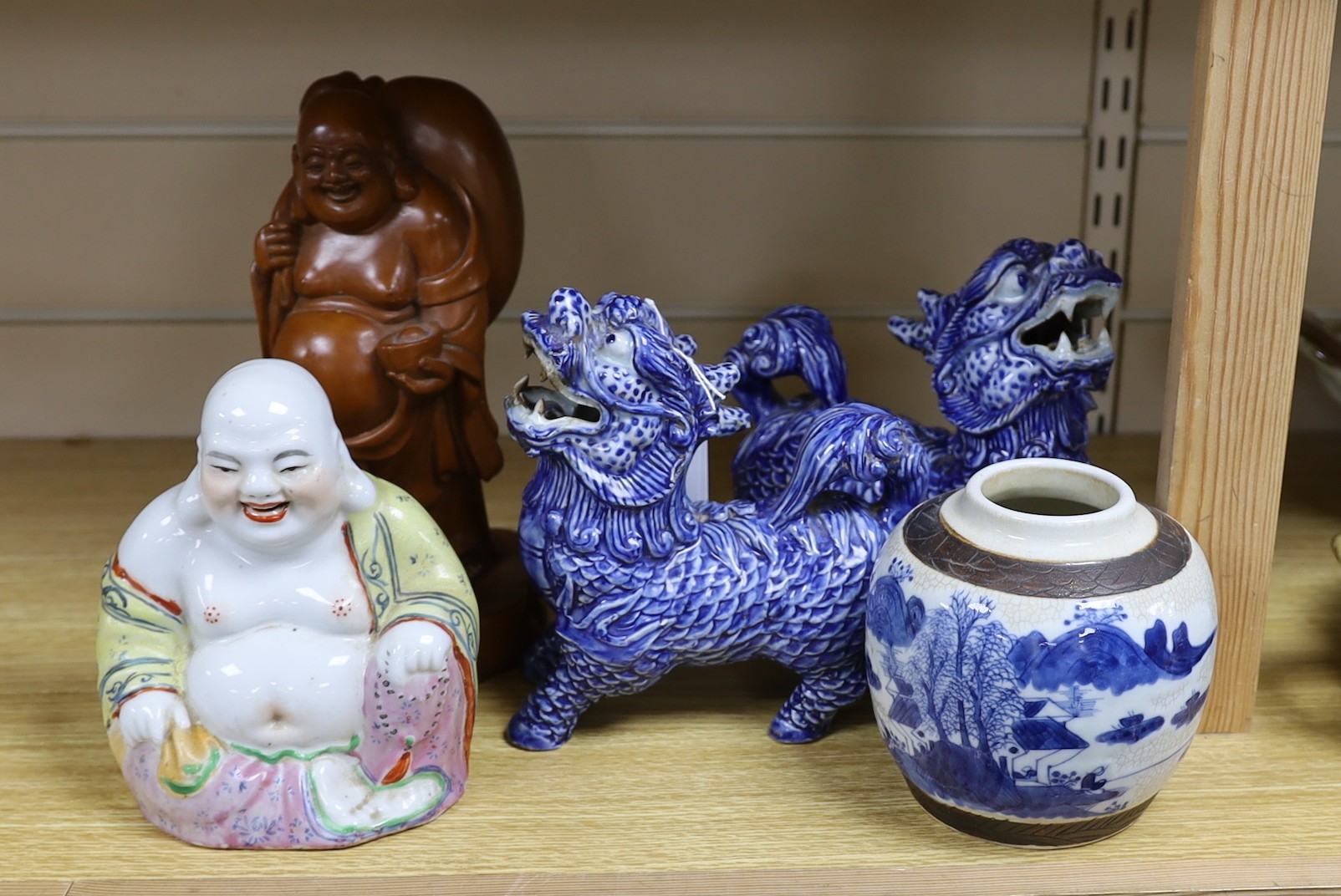 A pair of Chinese temple lions, two Buddha, 24cm high and a jar                                                                                                                                                             