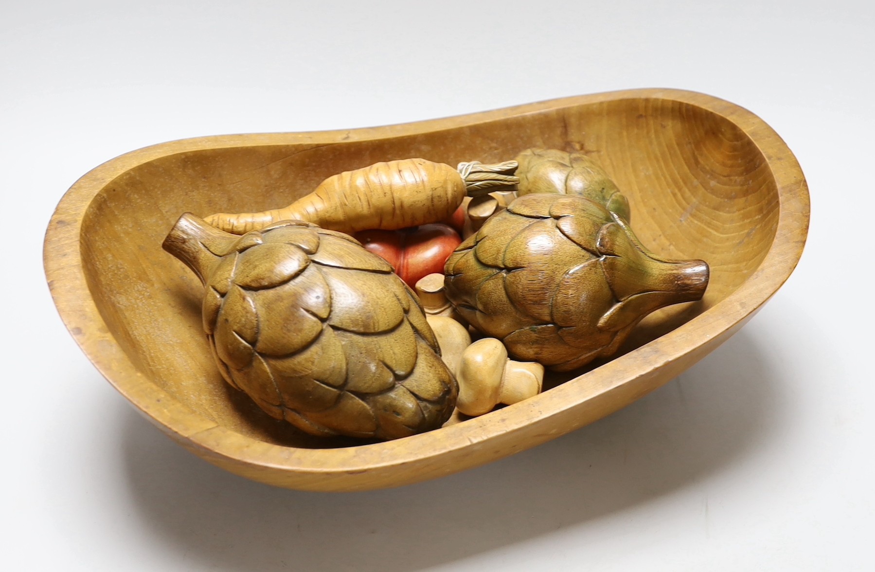 An Applewood bowl containing carved wooden fruit and vegetables, bowl 38cms wide                                                                                                                                            