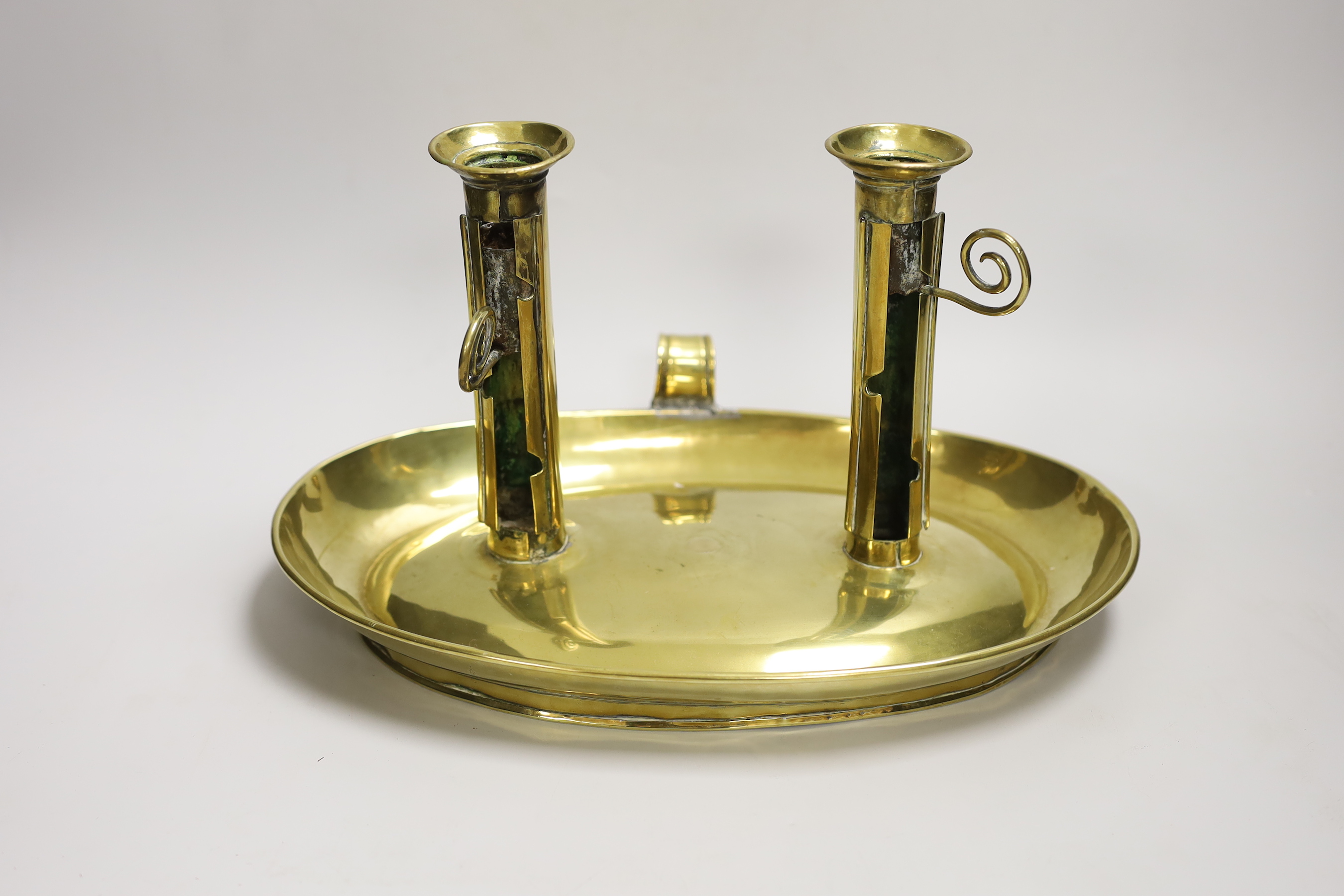 A large brass double chamber candlestick, English c.1800, with oval trap, 33cm wide                                                                                                                                         