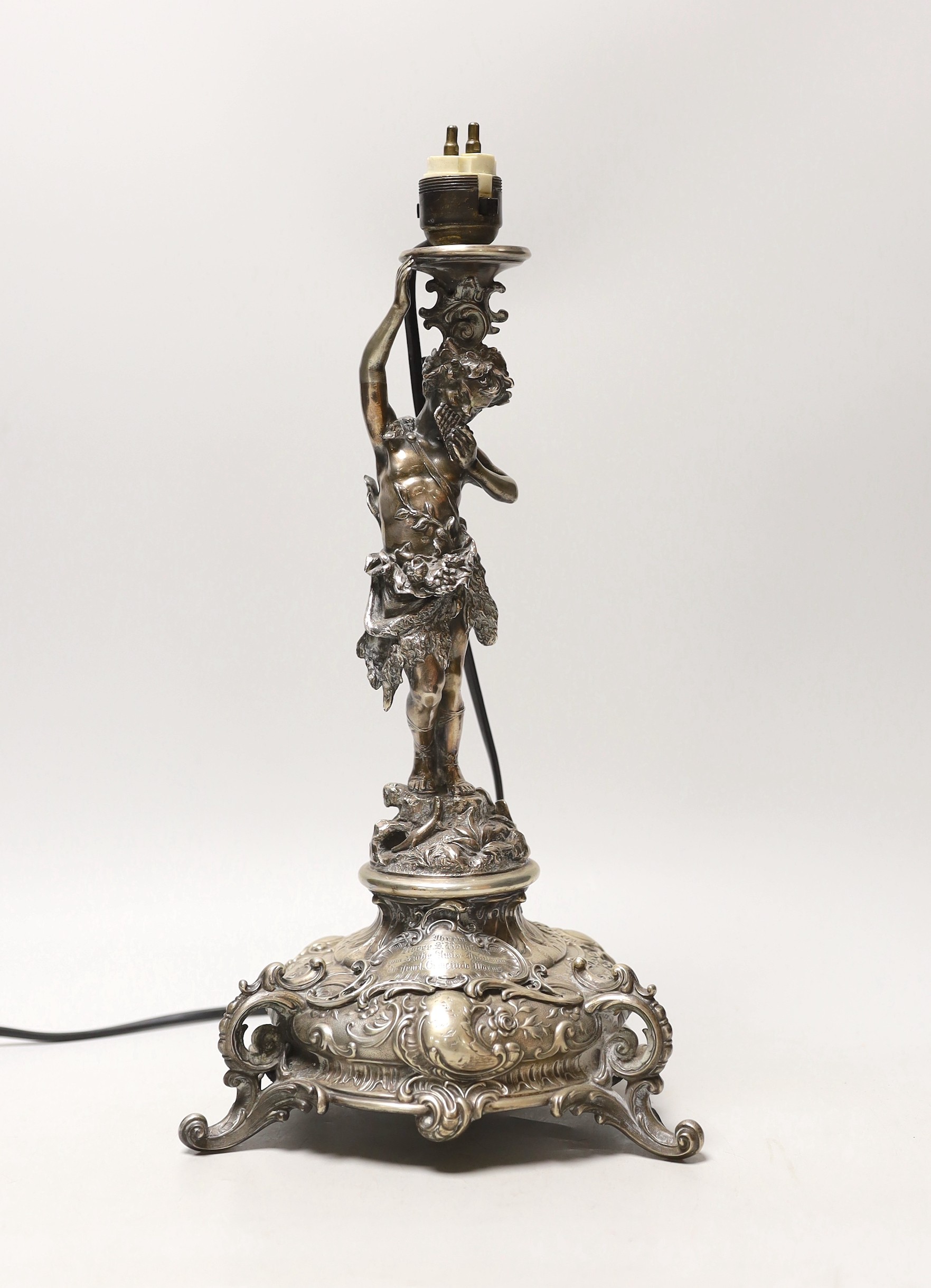 A late 19th century German 800 standard figural table lamp base, by Bruckmann & Sohne, height 37cm, gross weight 27.9oz.                                                                                                    
