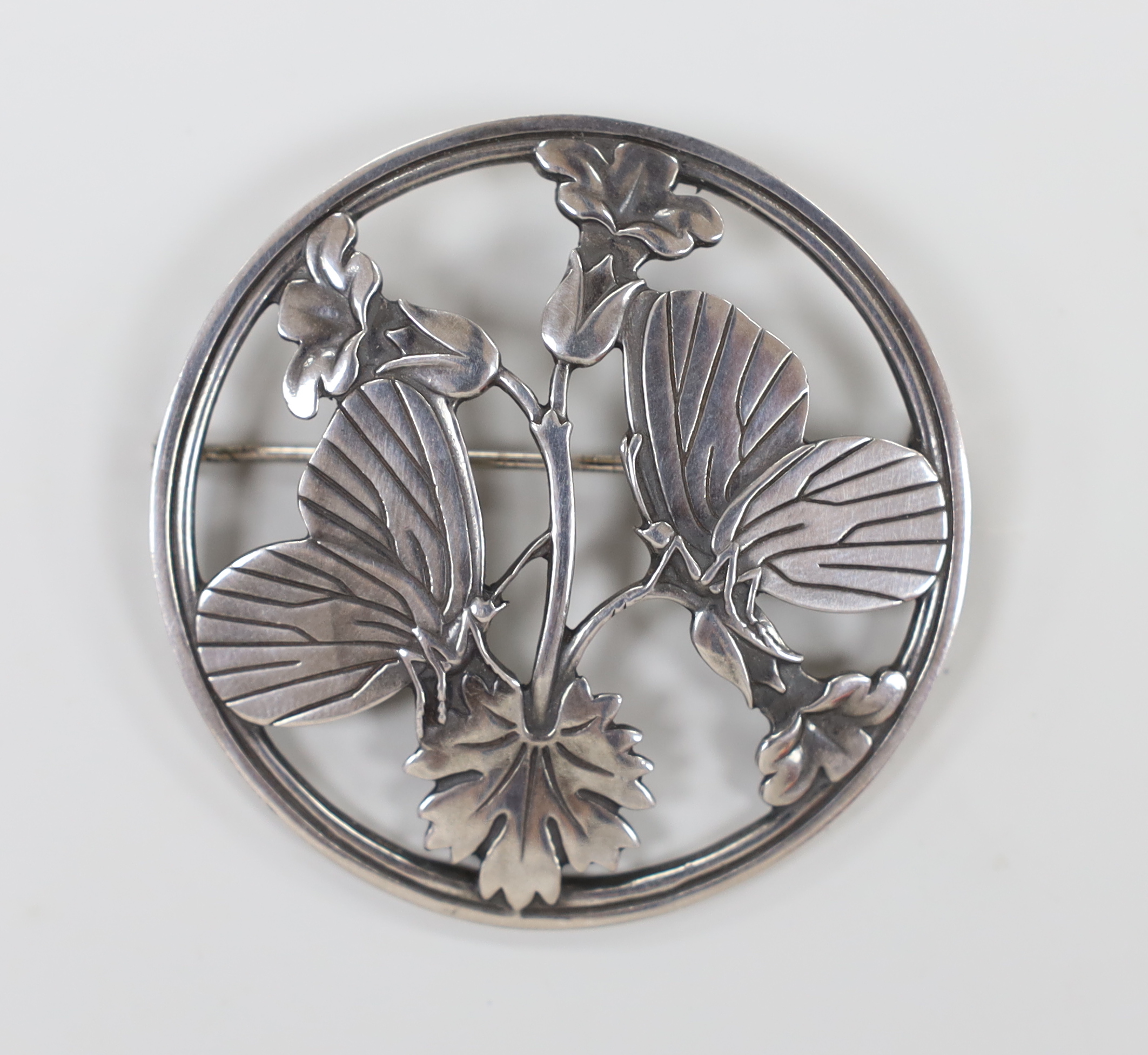 A Georg Jensen sterling 'moonlight Blossom' circular brooch, designed by Arno Malinowski, design no. 283, 52mm.                                                                                                             