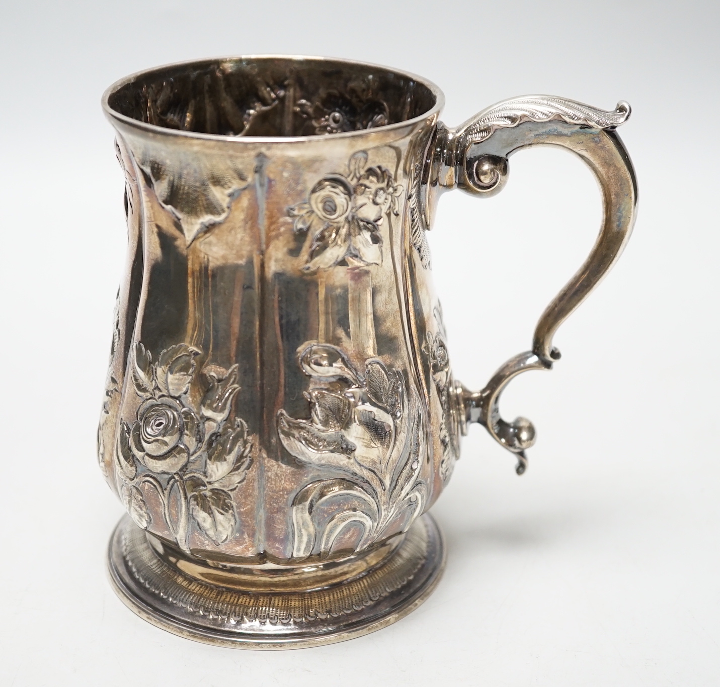 A George III silver baluster mug, with later embossed decoration, Joseph Steward?, London, 1763, 12.9cm, 11.8oz.                                                                                                            