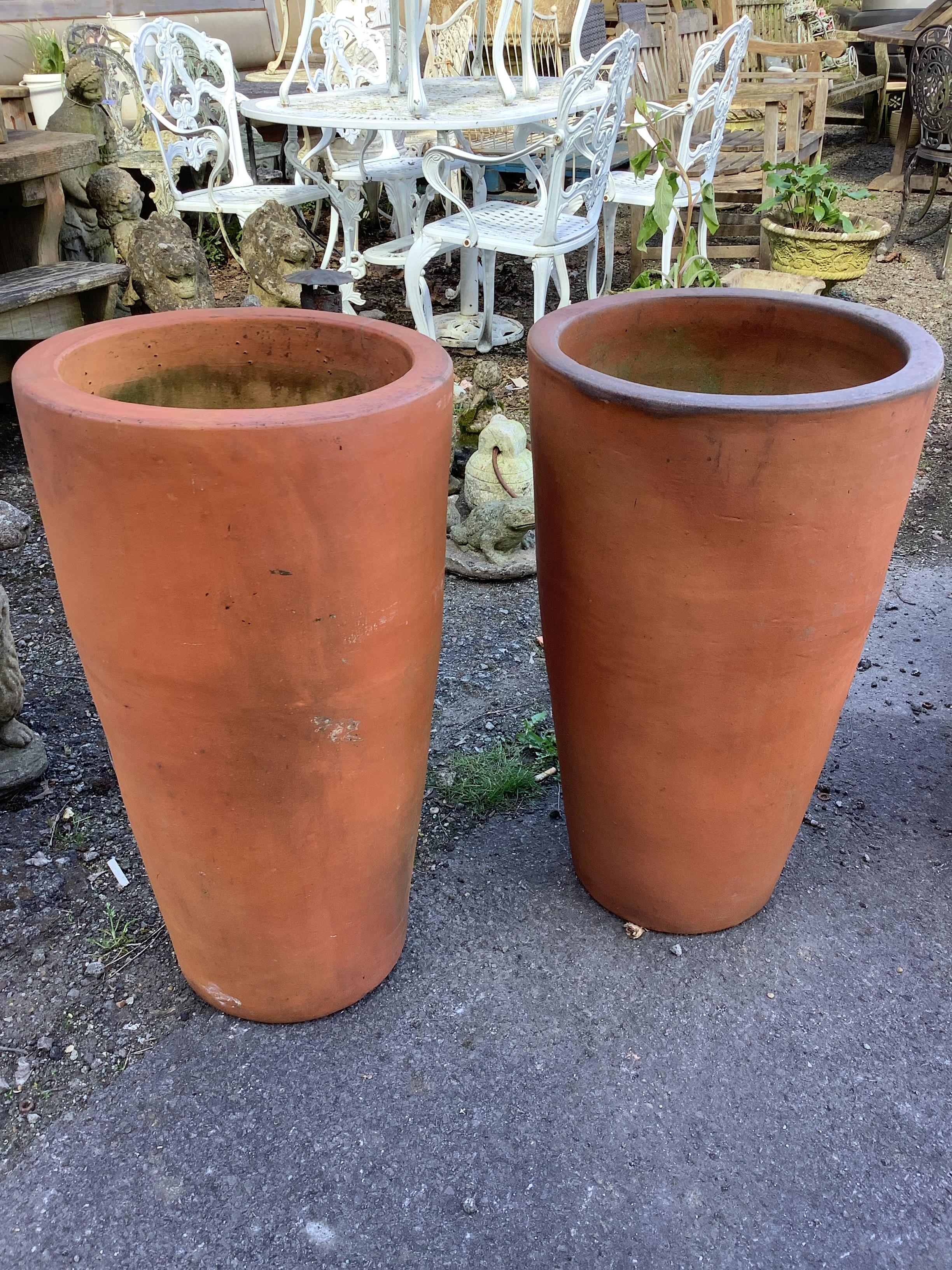A pair of tall circular terracotta garden planters, diameter 38cm, height 71cm                                                                                                                                              