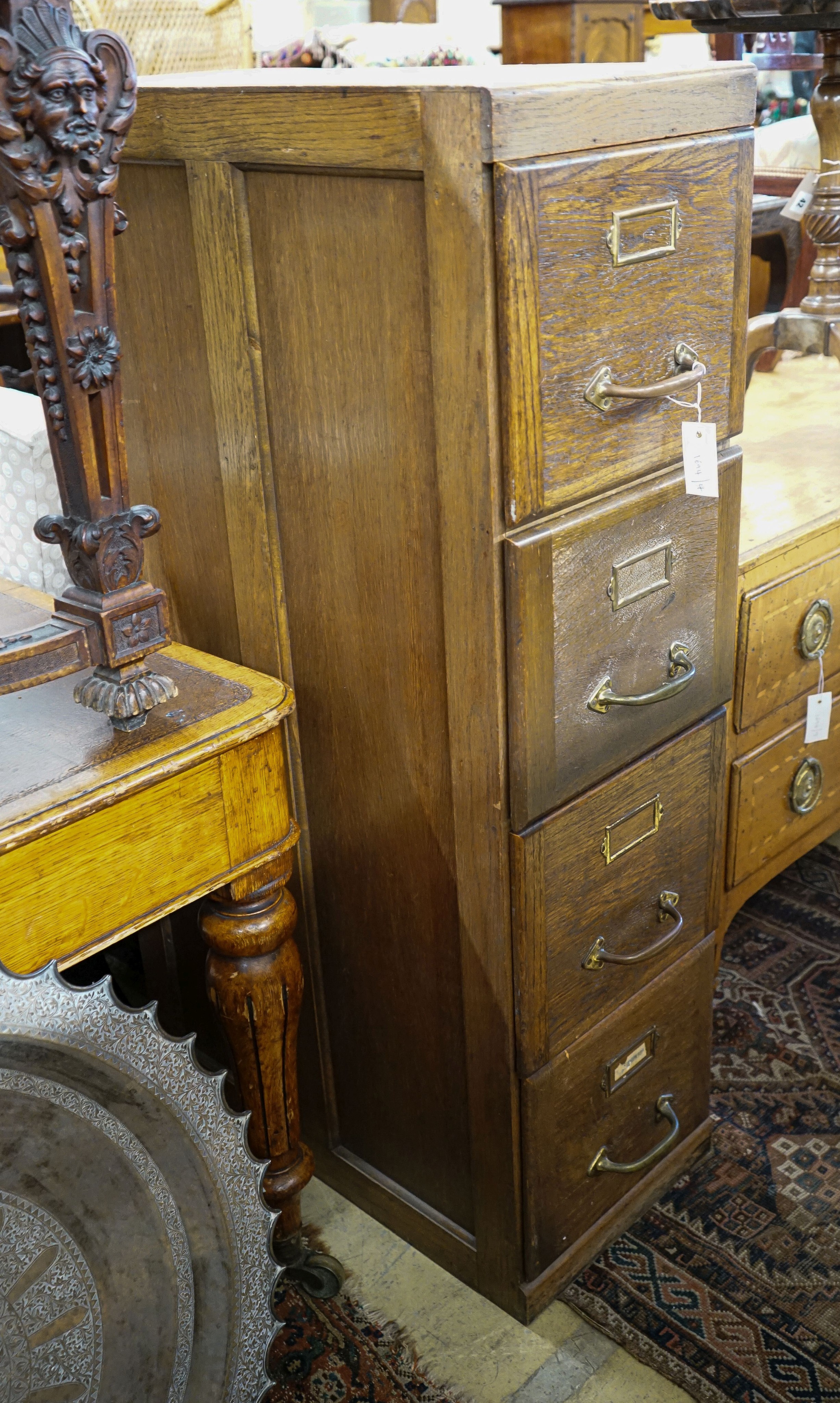 An early 20th century oak four drawer filing cabinet, width 37cm, depth 70cm, height 130cm                                                                                                                                  