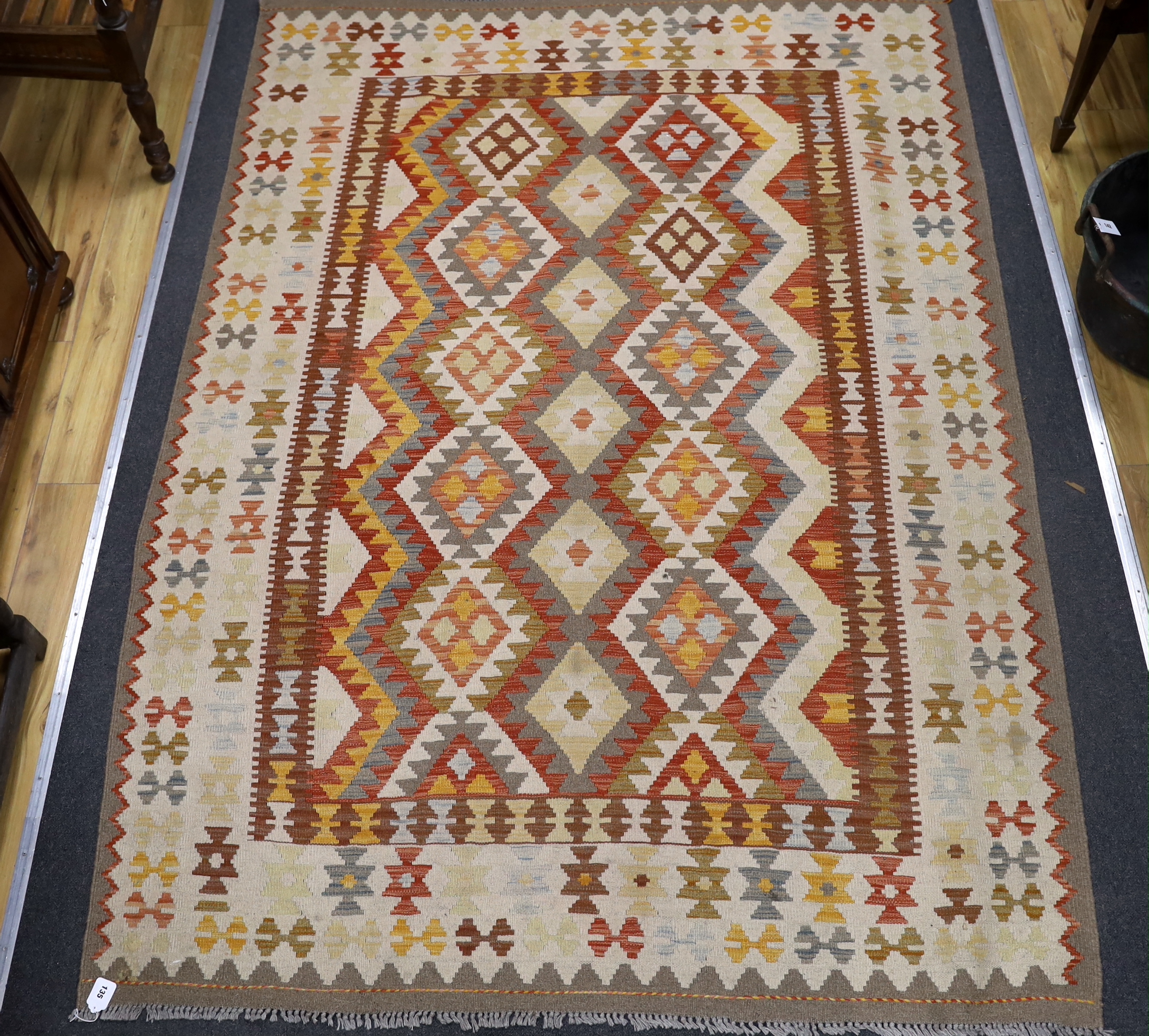 A Kilim polychrome geometric carpet, 250 x 177cm                                                                                                                                                                            