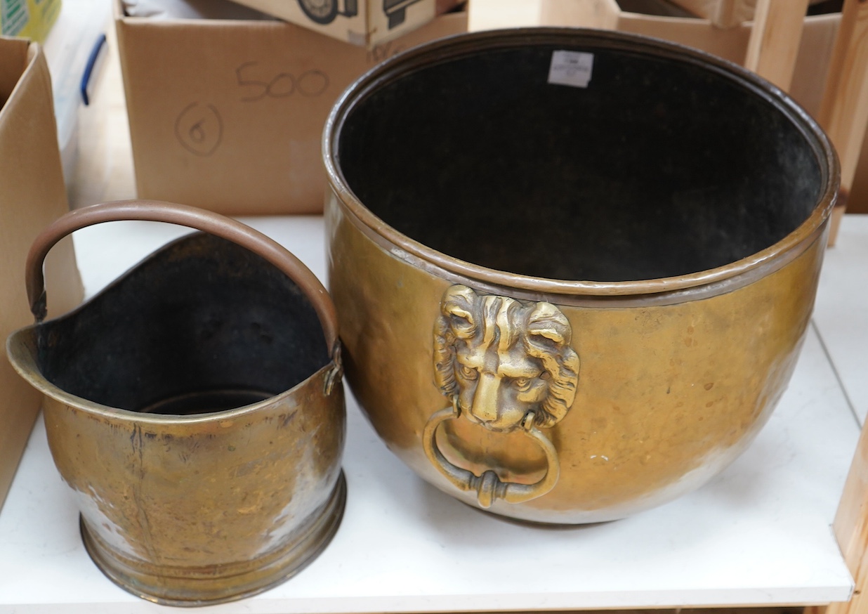 A circular brass log bin with lion head handles and a coal scuttle, tallest 35.5cm. Condition - fair                                                                                                                        