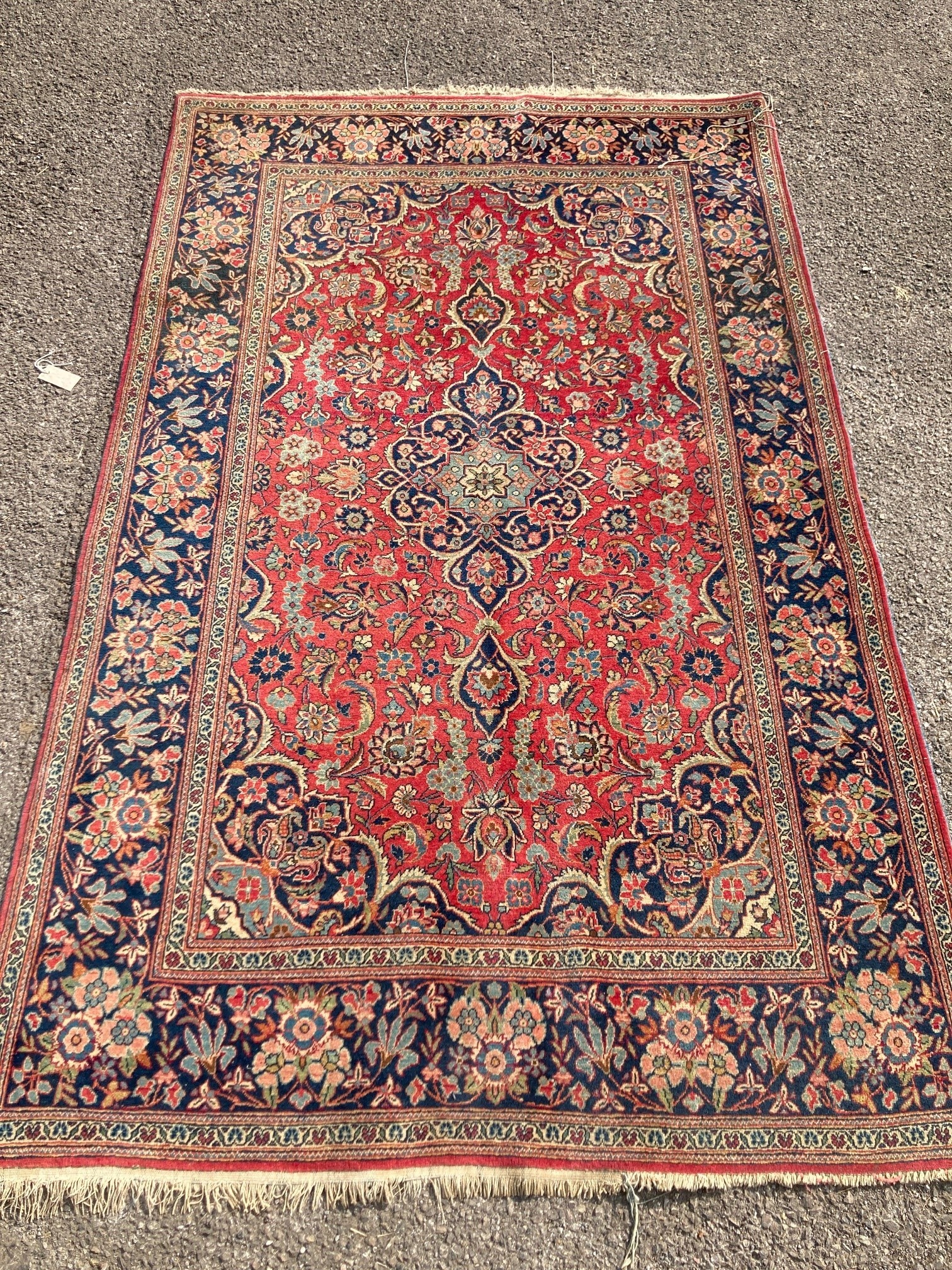 A Kashan red ground rug, with all-over stylised floral motifs                                                                                                                                                               