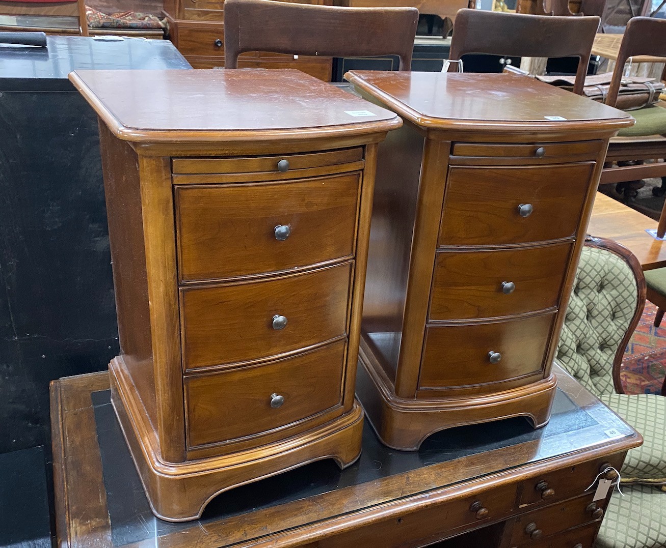 A pair of reproduction cherry three drawer bedside chests with slides, width 43cm, depth 42cm, height 68cm                                                                                                                  